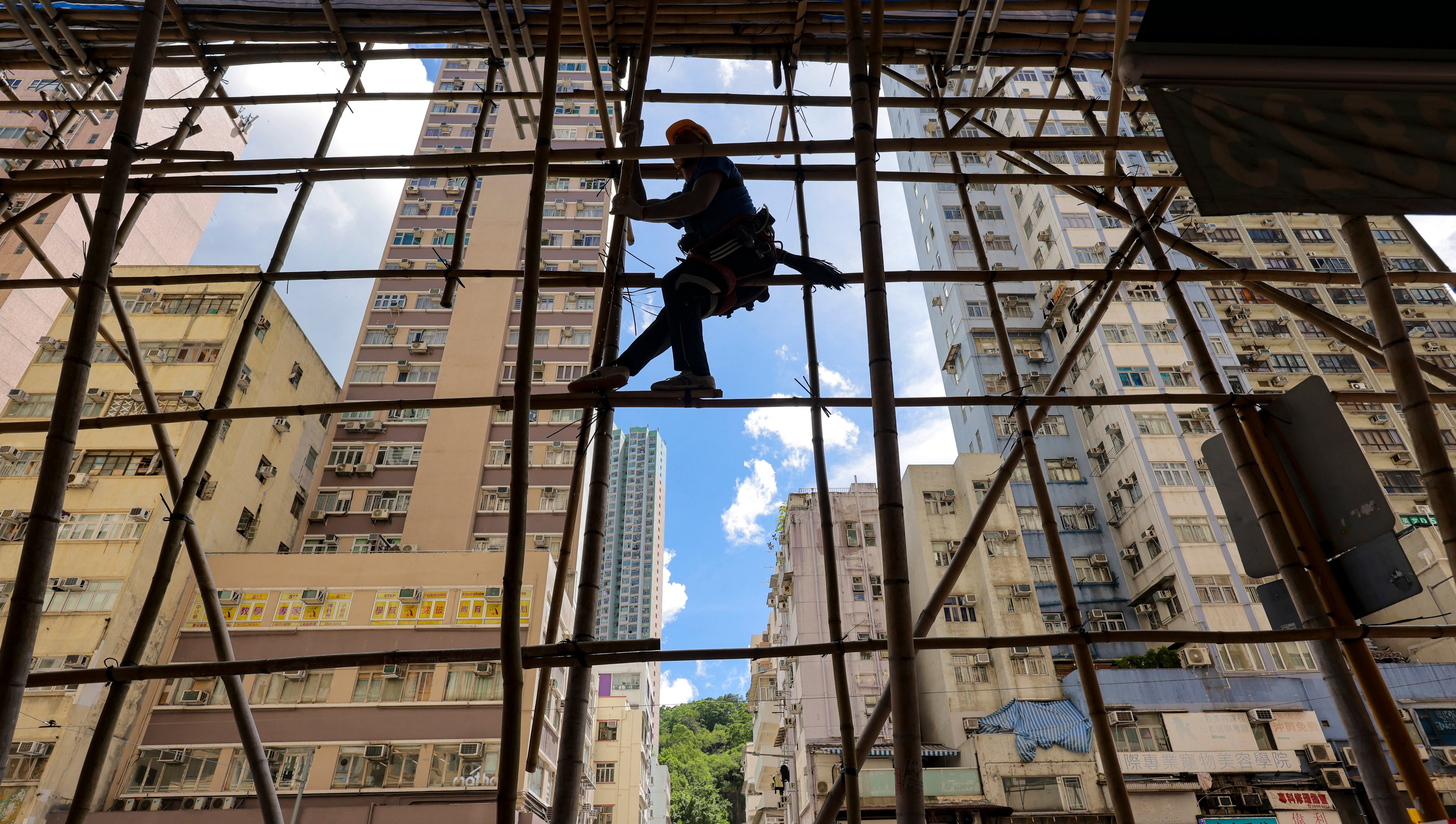 A worker erects scaffolding at a site in Shau Kei Wan. The number of private buildings aged 50 or above in Hong Kong is projected to rise from 8,700 in 2020 to about 13,900 by 2030. Photo: Jelly Tse