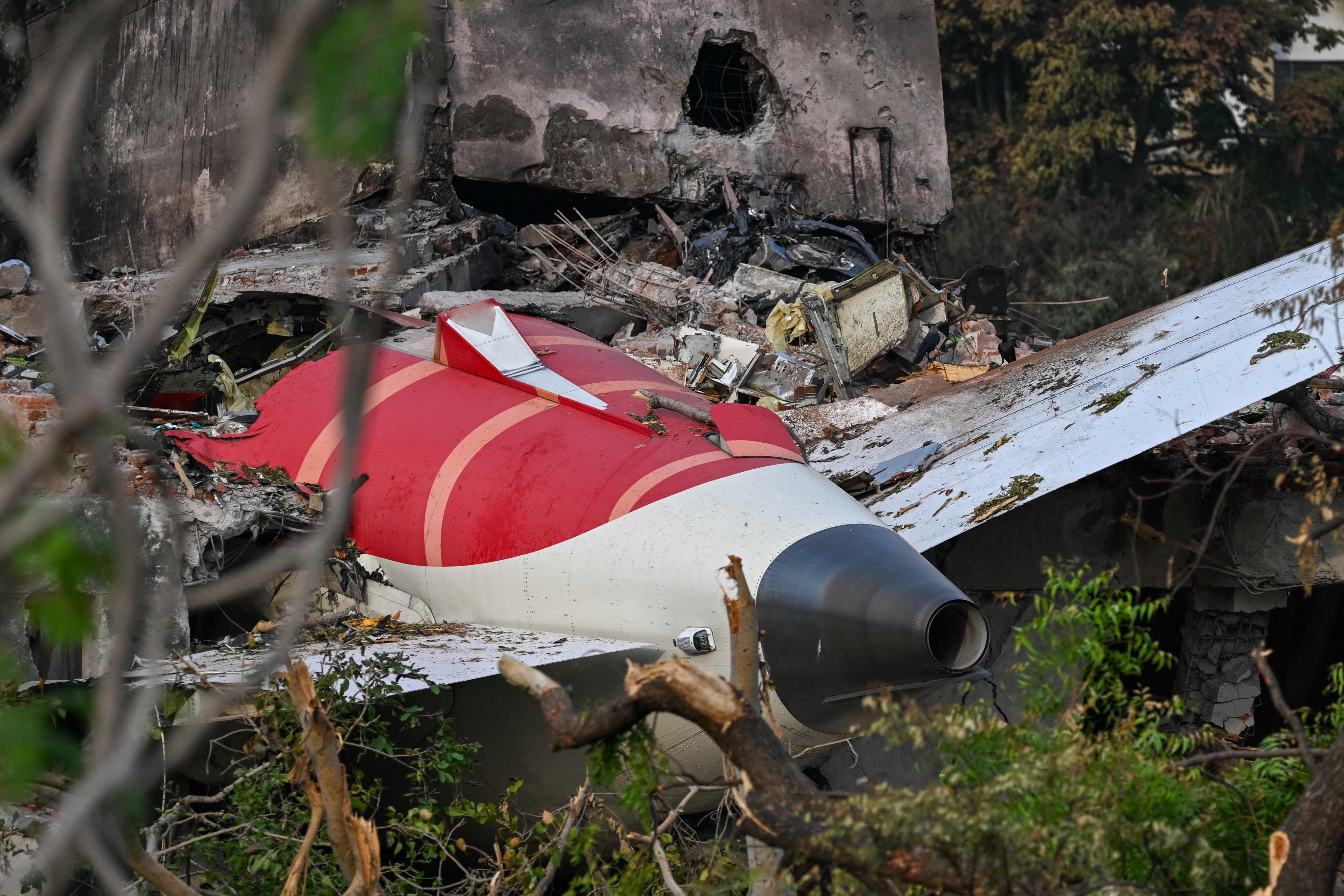 The tail section of the Air India Boeing 787-8 is pictured in a residential area near the airport in Ahmedabad on Saturday, after the aircraft crashed shortly after taking off on Thursday. Photo: AFP