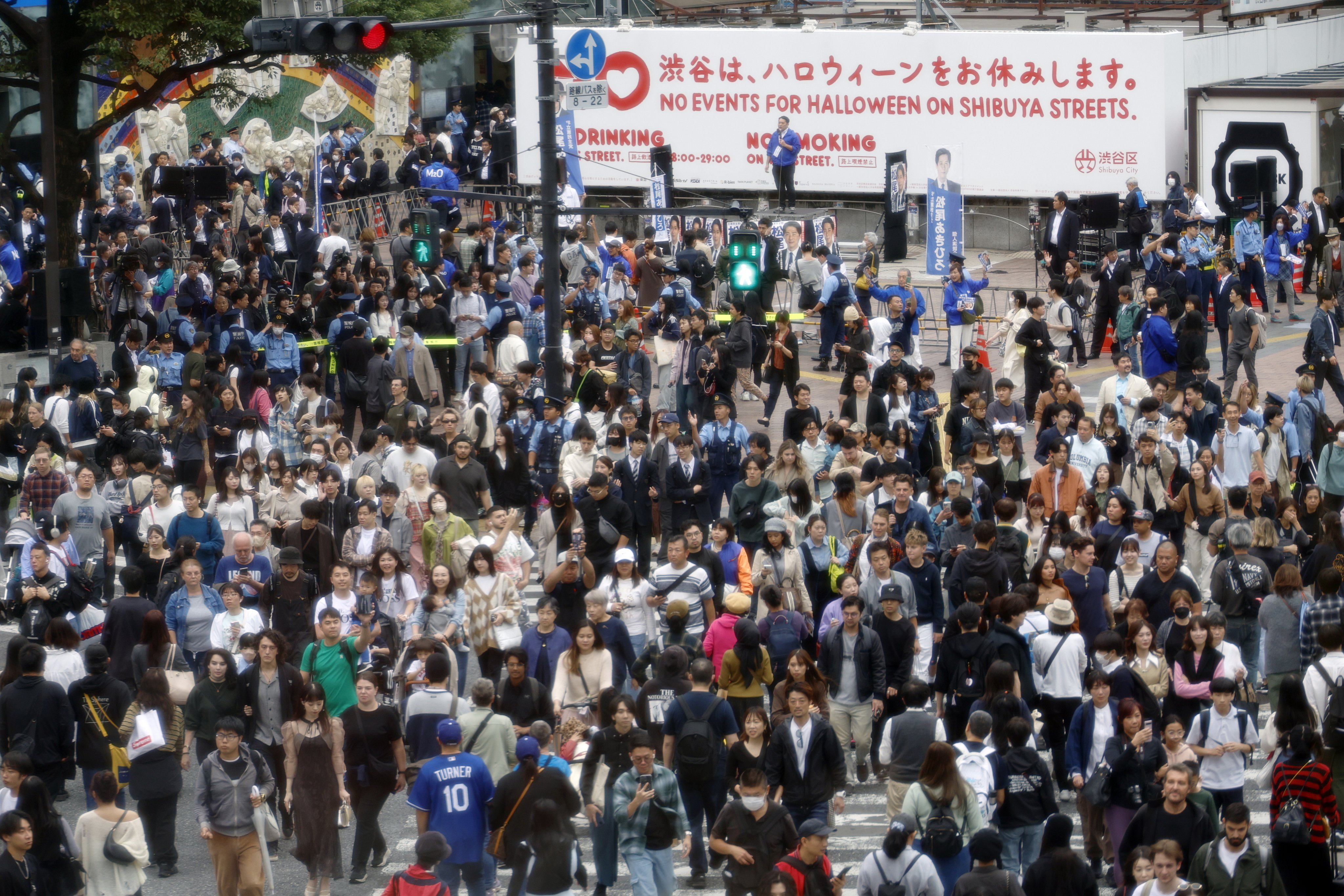 A member of the main opposition Constitutional Democratic Party of Japan delivers a stump speech at Shibuya crossing on October 26, last year. Photo: EPA-EFE