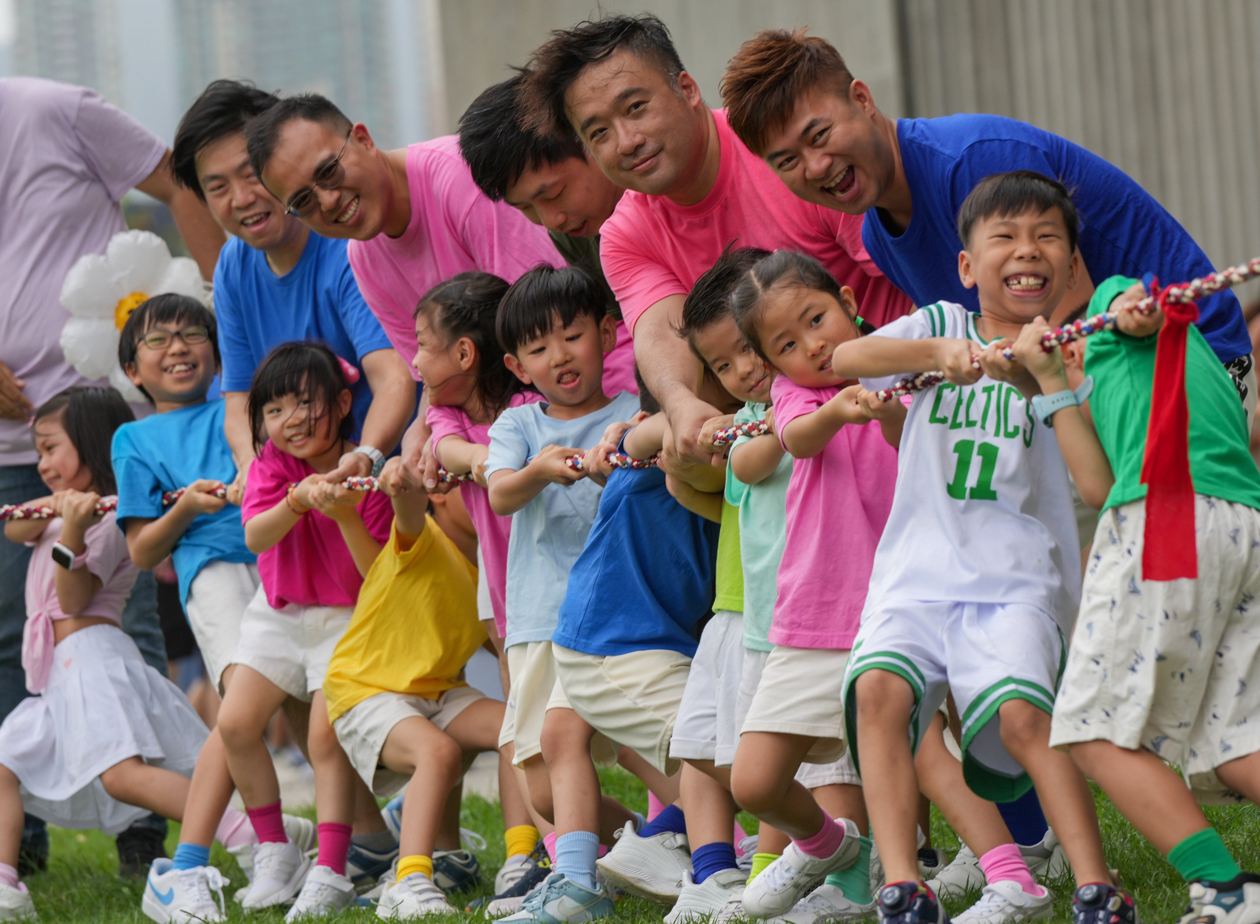 Dads join their children at a tug of war during an outing. The DADs Network has worked with more than 150 schools and reached over 10,000 fathers, children and family members across the city. Photo: May Tse