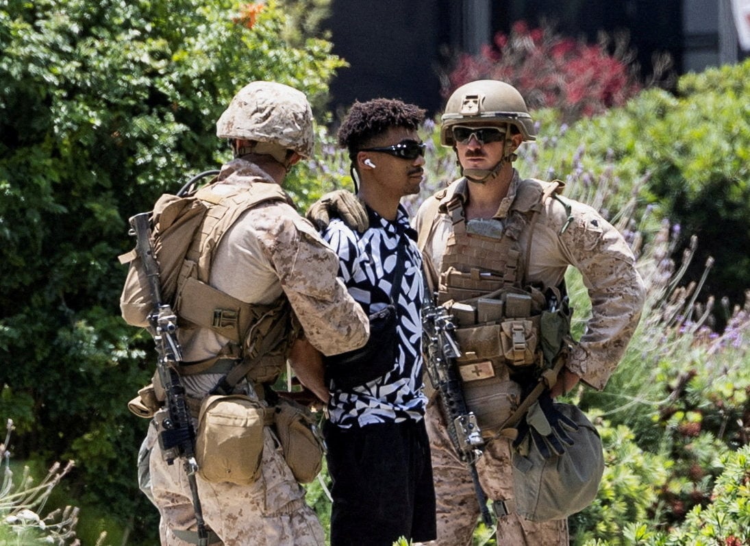 US Marines detain a man outside the Wilshire Federal Building in Los Angeles. Photo: Reuters
