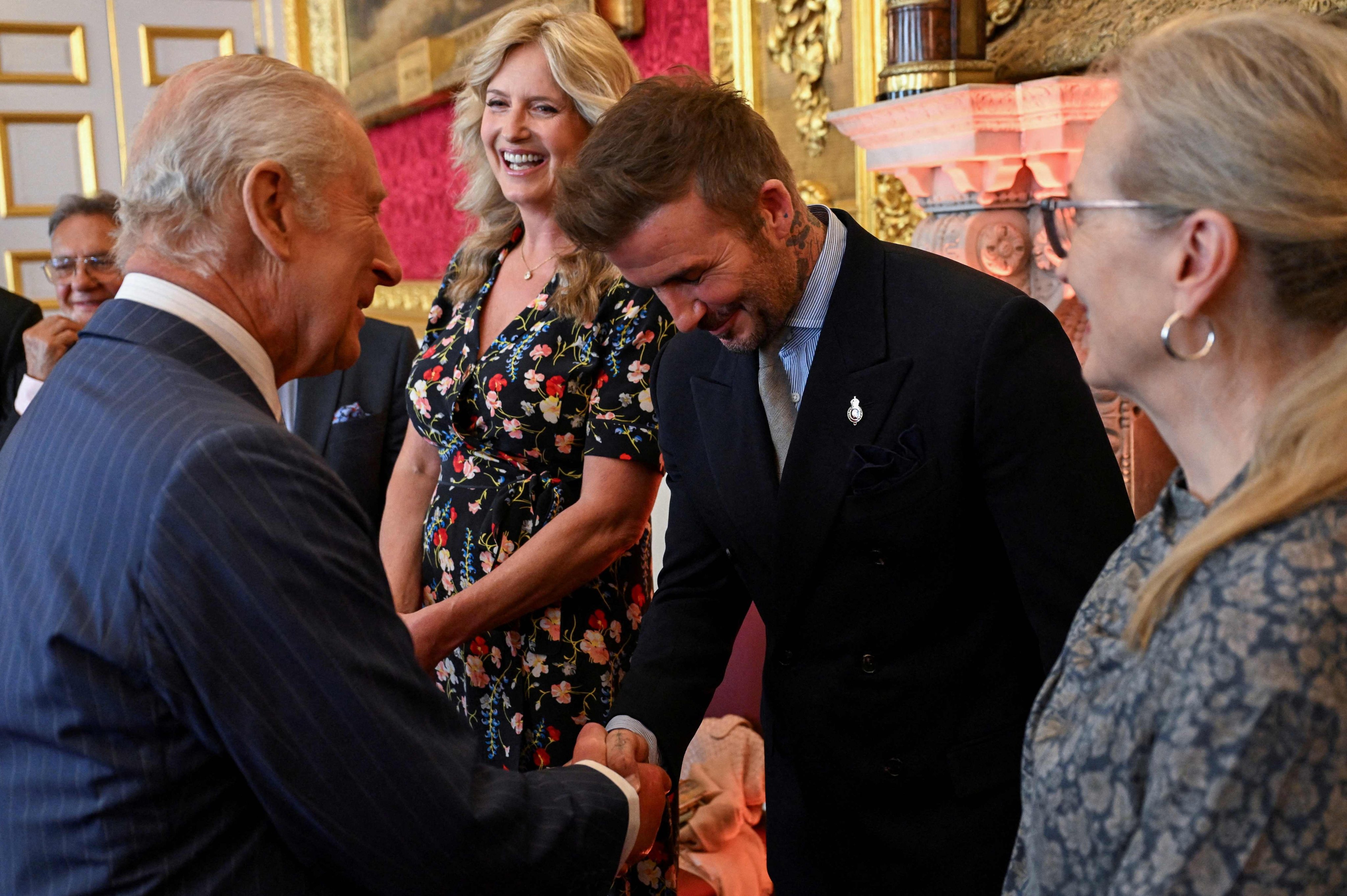 David Beckham (right) shakes hands with Britain’s King Charles III (left) during the King’s Foundation Awards ceremony on Thursday. Photo: AFP
