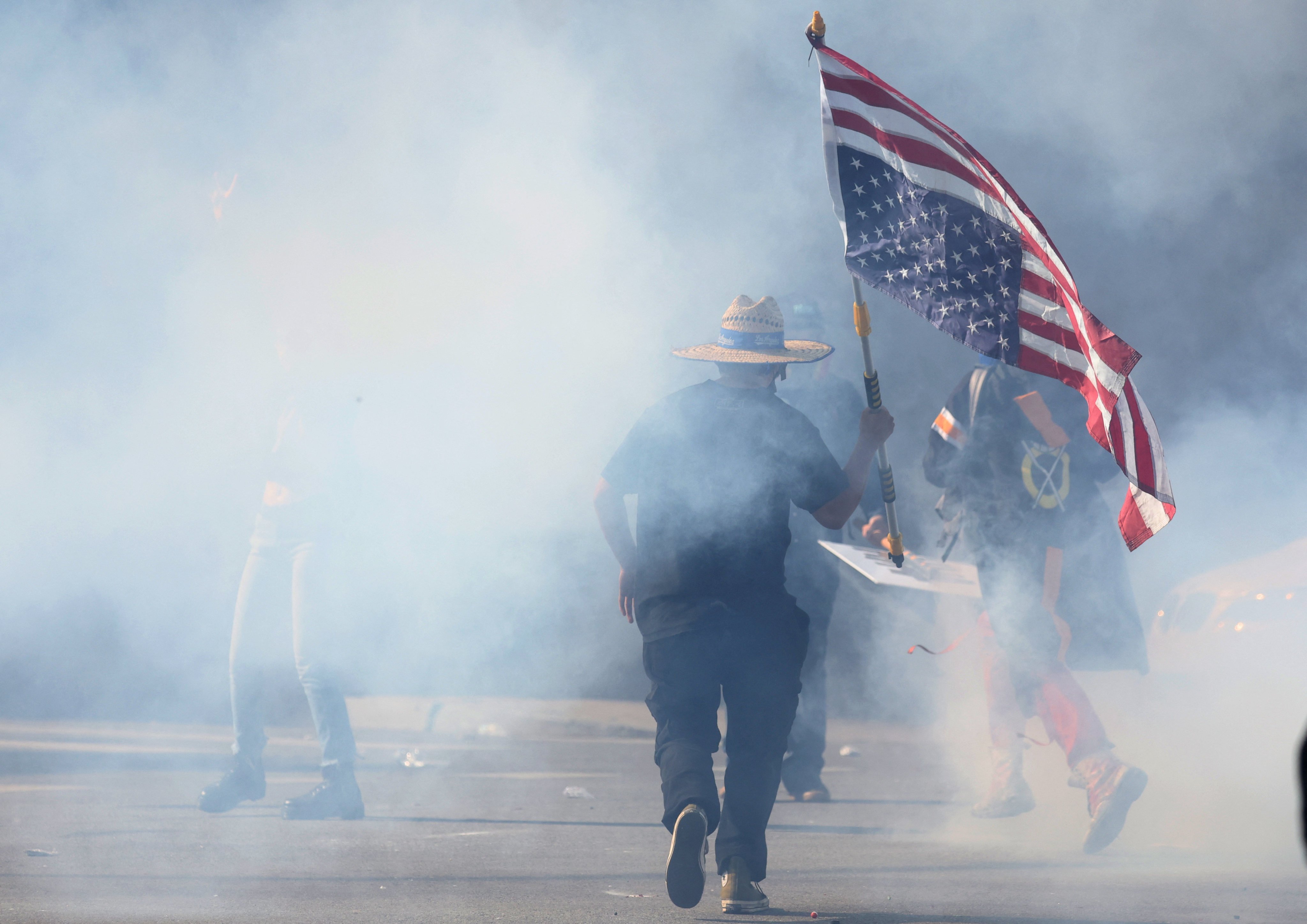 A demonstrator runs through tear gas during a “No Kings” protest against US President Donald Trump’s policies and federal immigration sweeps, in Los Angeles, California, on Saturday. Photo: Reuters