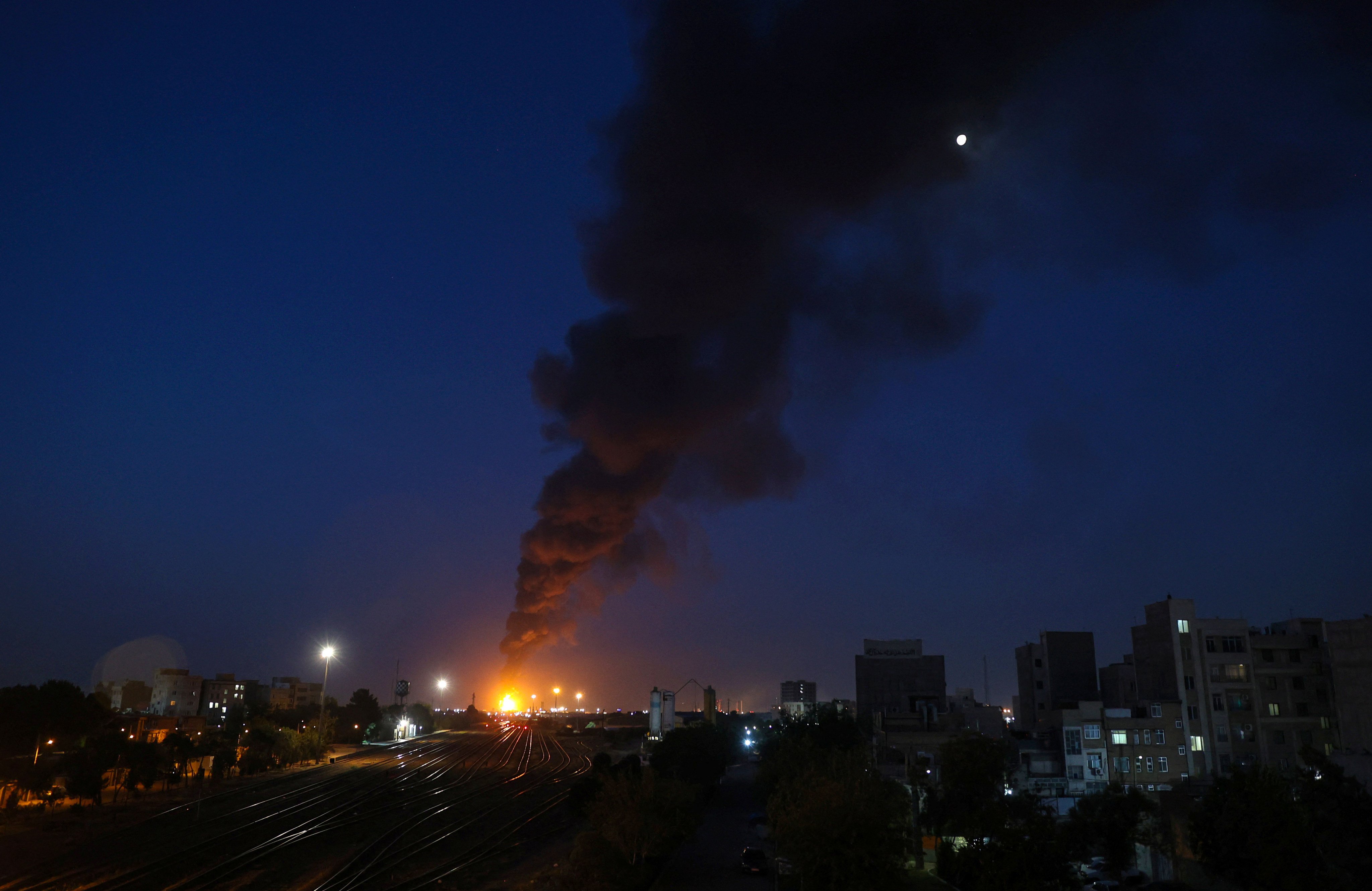 Fire and smoke are seen near Tehran on Sunday following an Israeli strike on the Iranian capital. Photo: via Reuters