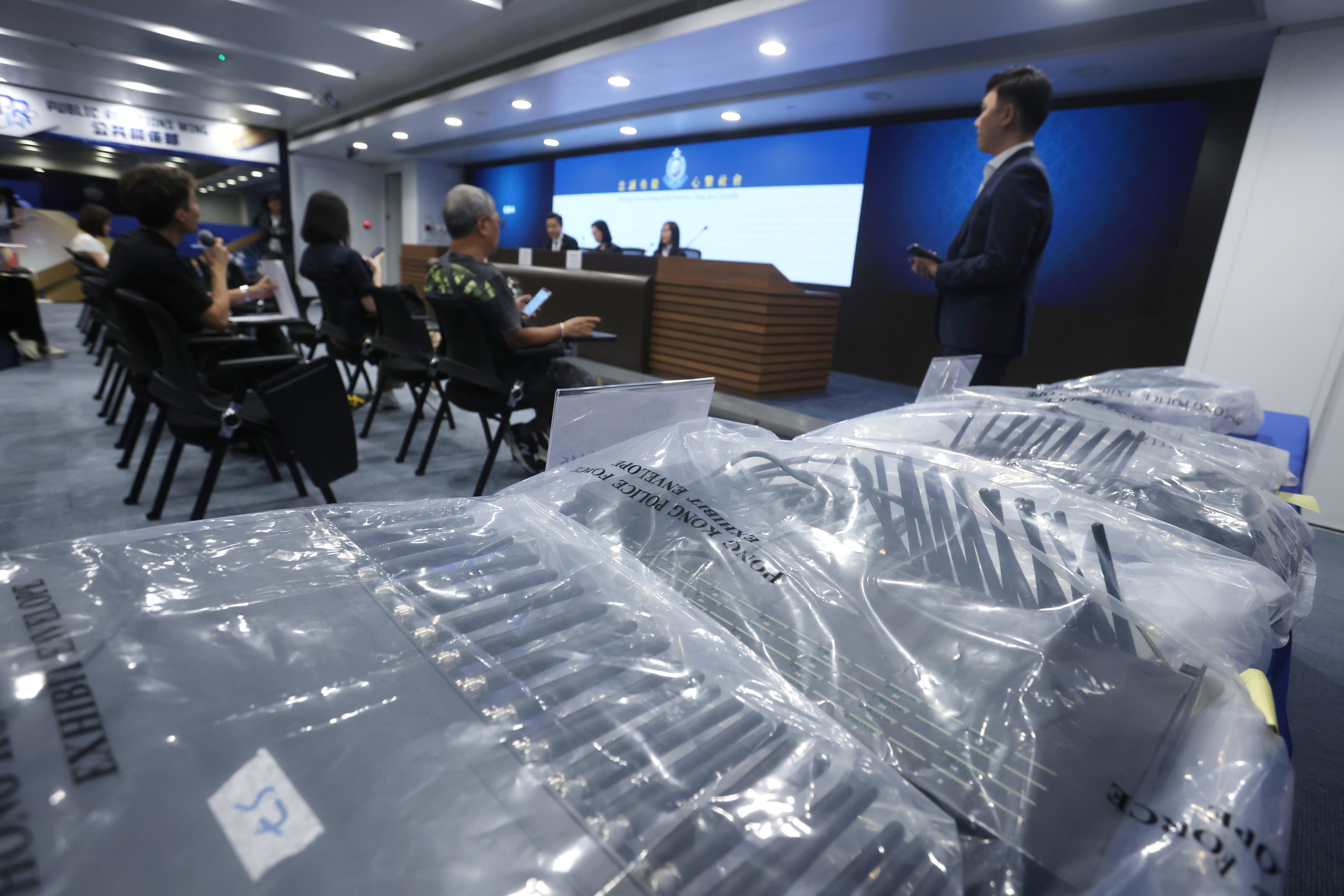 Police display telecoms devices seized as part of the joint operation with Singapore. Photo: Jonathan Wong