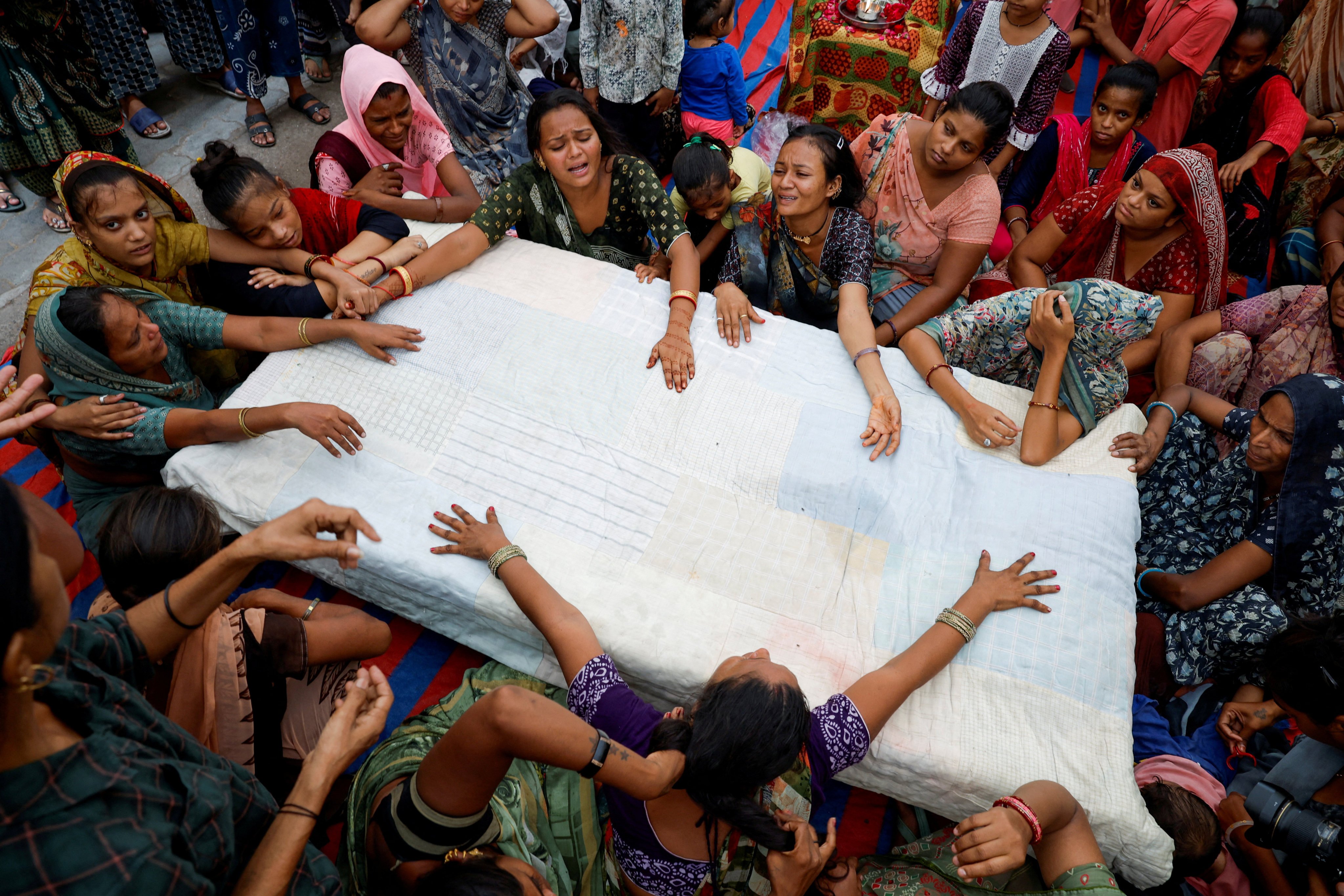 Relatives mourn as they wait for the body of Akash Patni, 14, who died after an Air India Boeing 787-8 Dreamliner plane crashed during take-off from an airport, to arrive at his house for the last rites in Ahmedabad, India, on Sunday. Photo: Reuters