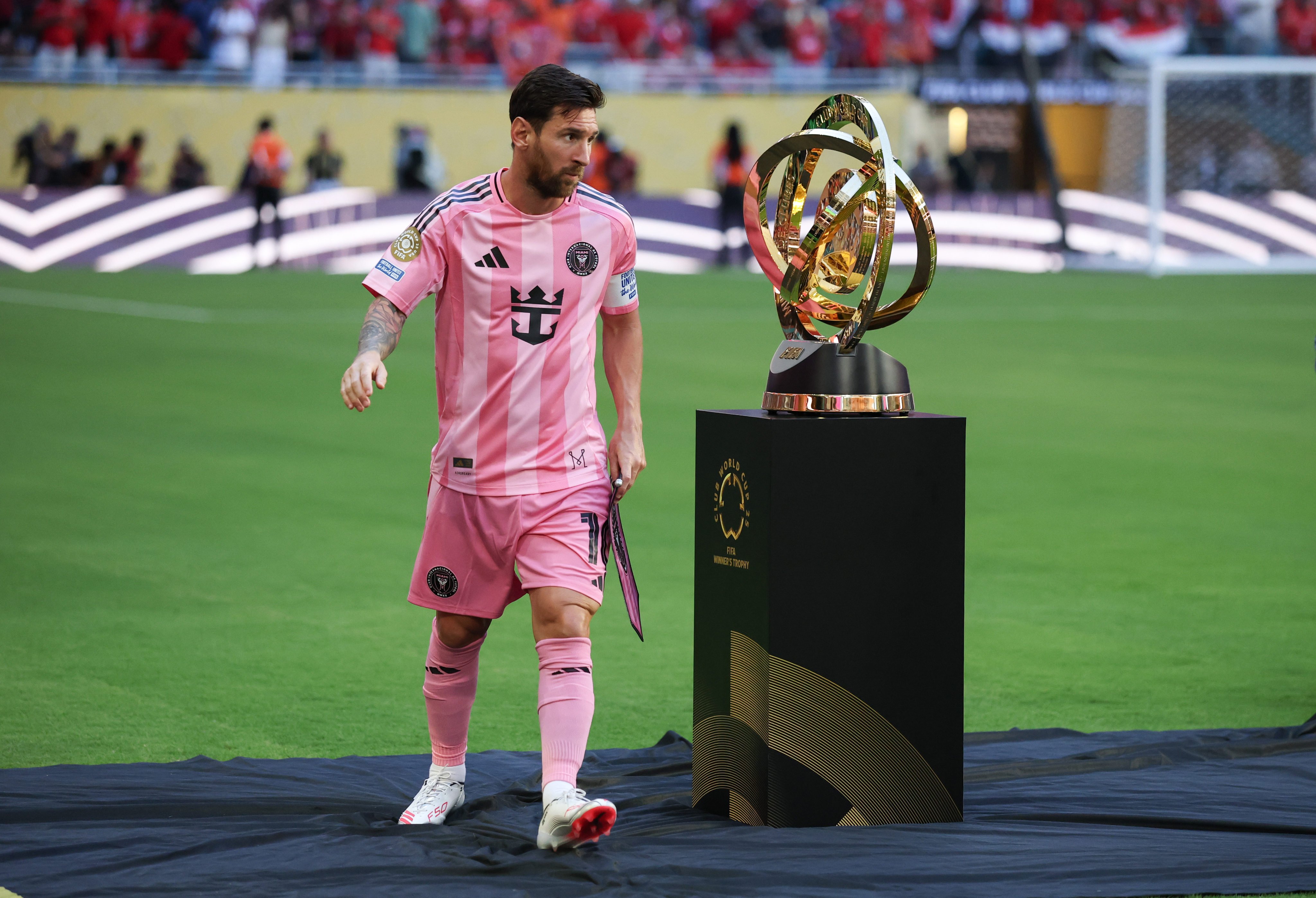 Lionel Messi passes the Club World Cup trophy before the opening match between Inter Miami and Al-Ahly in Florida. Photo: Xinhua