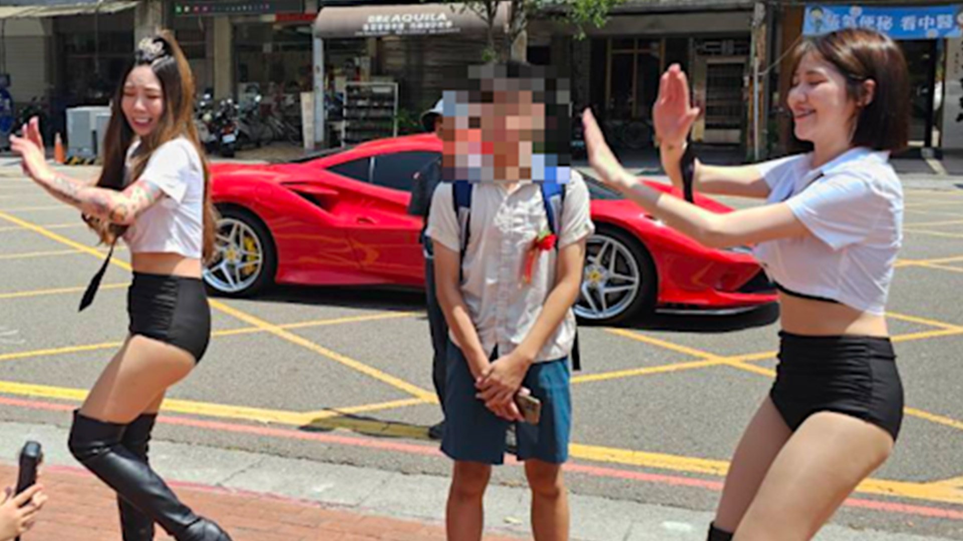 Parents in Taiwan hired pole dancers to perform outside their son’s school as a special graduation gift. Photo: Yahoo.tw