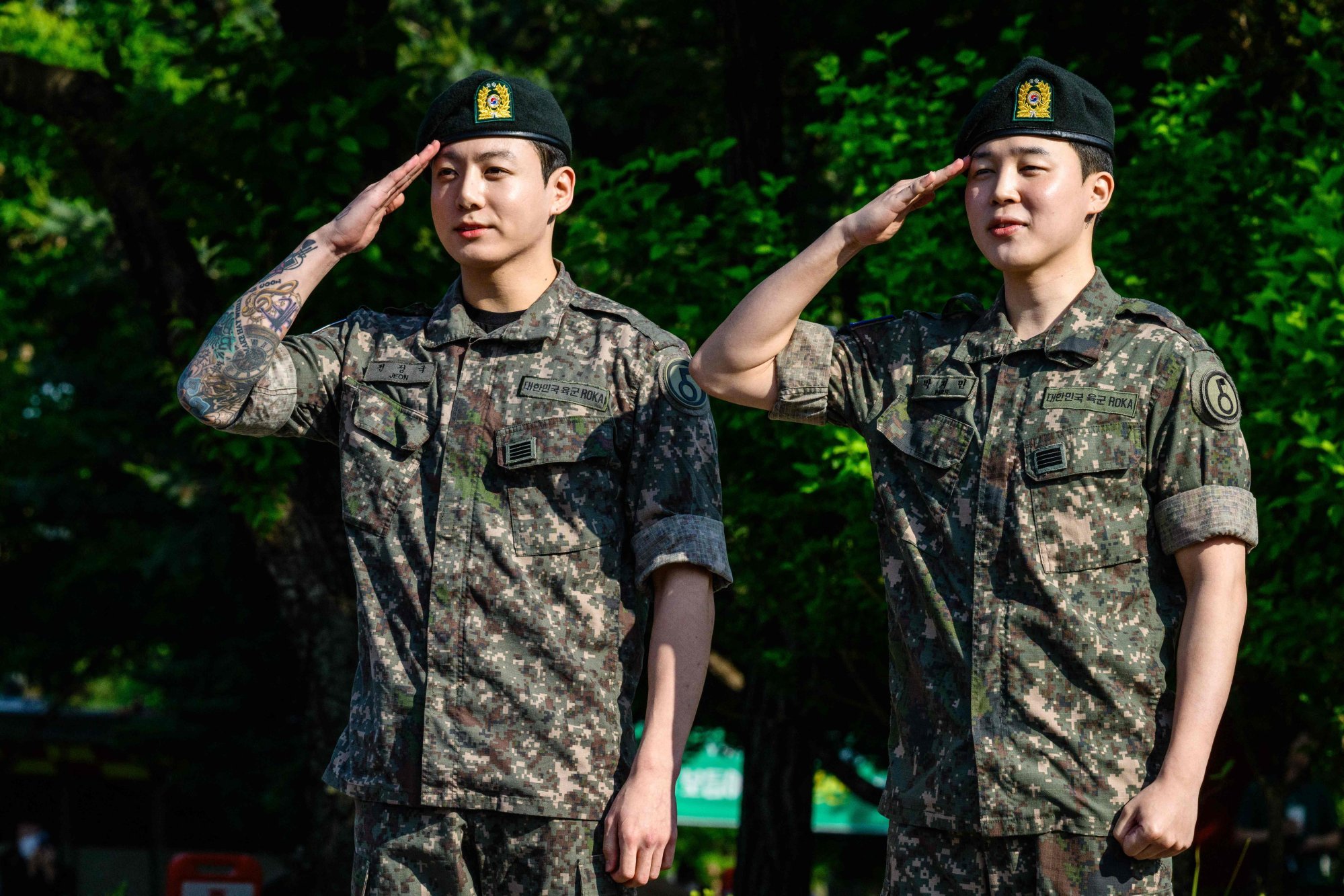 BTS members Jungkook and Jimin salute at a sporting facility in Yeoncheon on June 11, shortly after completing their 18-month mandatory military service. Photo: AFP BTS members Jungkook and Jimin salute at a sporting facility in Yeoncheon on June 11, shortly after completing their 18-month mandatory military service. Photo: AFP
