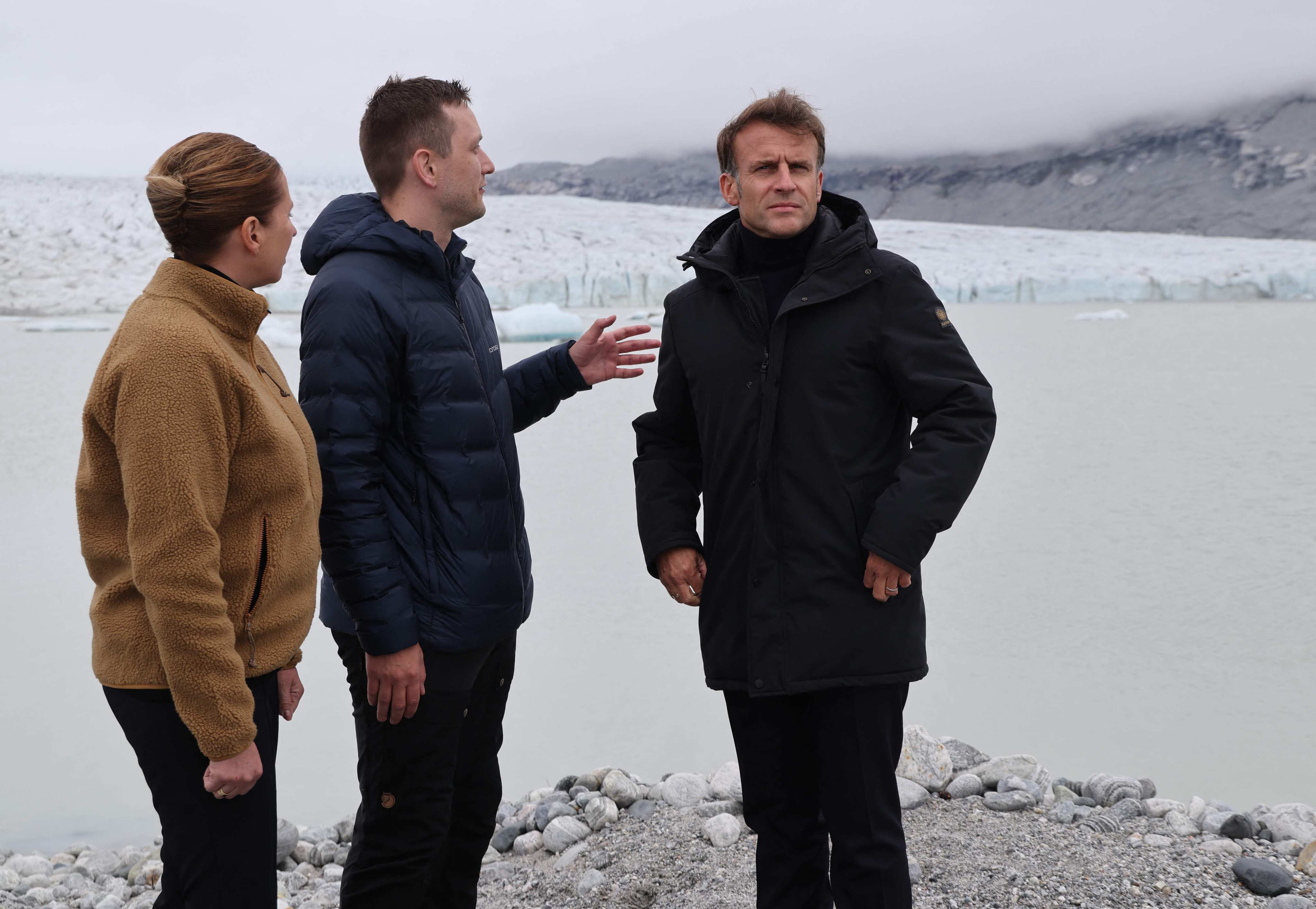 French President Emmanuel Macron, right Greenland’s Prime Minister Jens-Frederik Nielsen, centre, and Danish Prime Minister Mette Frederiksen walk on the glacier Mont Nunatarsuaq during a visit in Greenland on Sunday. Photo: AFP