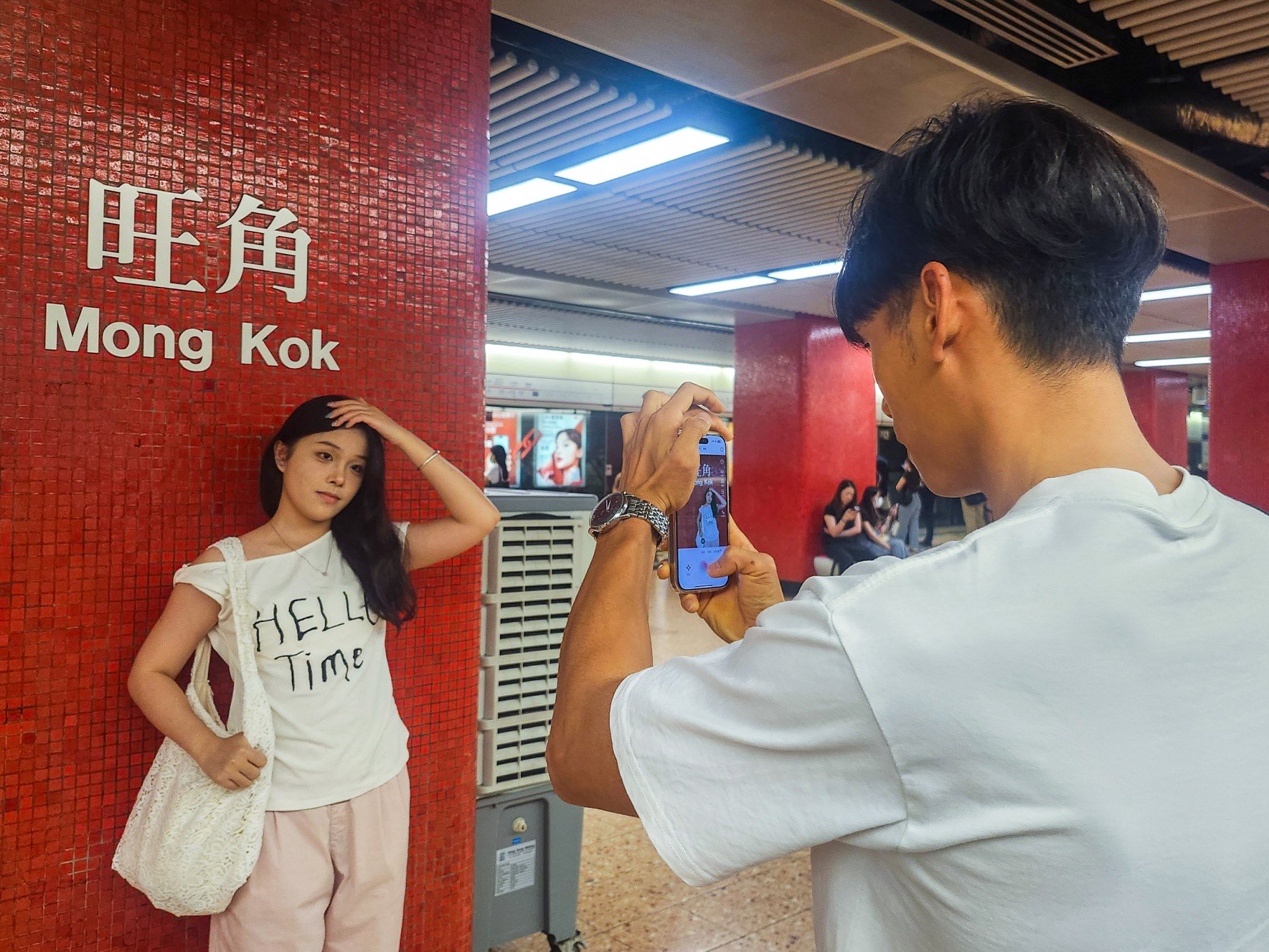 A mainland visitor poses next to the Mong Kok MTR station sign. The station and the Tsim Sha Tsui one are particularly popular with tourists from across the border. Photo: Timon Johnson A mainland visitor poses next to the Mong Kok MTR station sign. The station and the Tsim Sha Tsui one are particularly popular with tourists from across the border. Photo: Timon Johnson