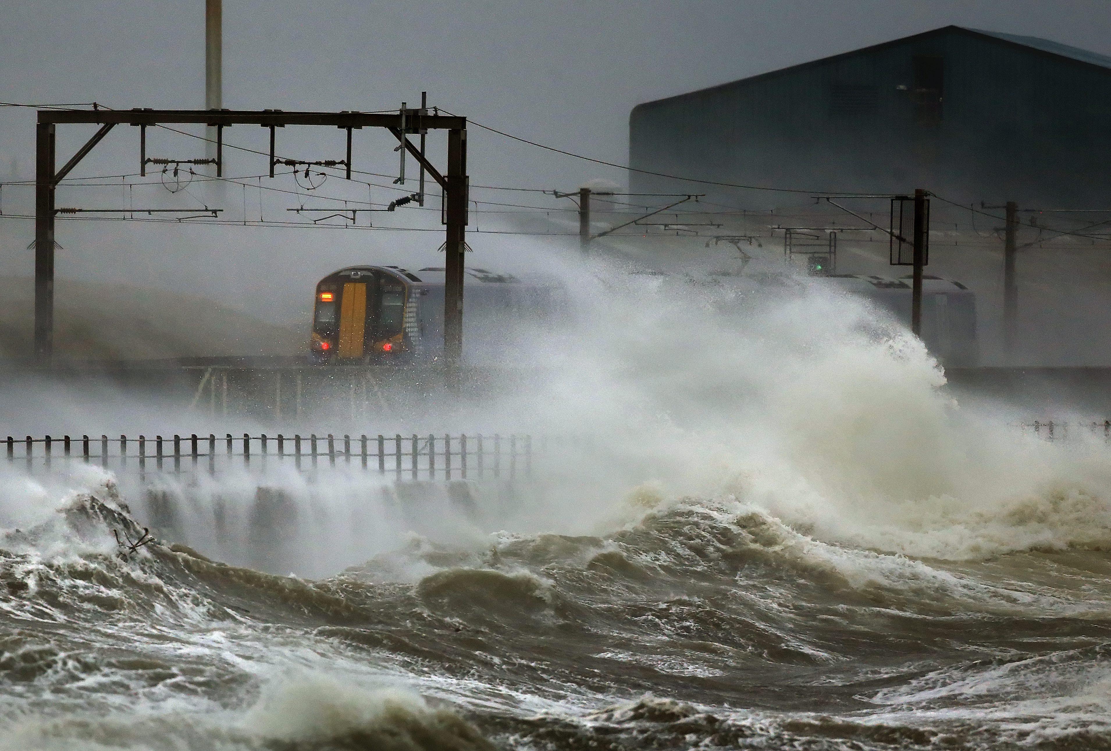A train passes along the coast in Scotland. Many train services in Britain have been delayed or cancelled in recent years due to increasingly severe weather. File photo: EPA/EFE