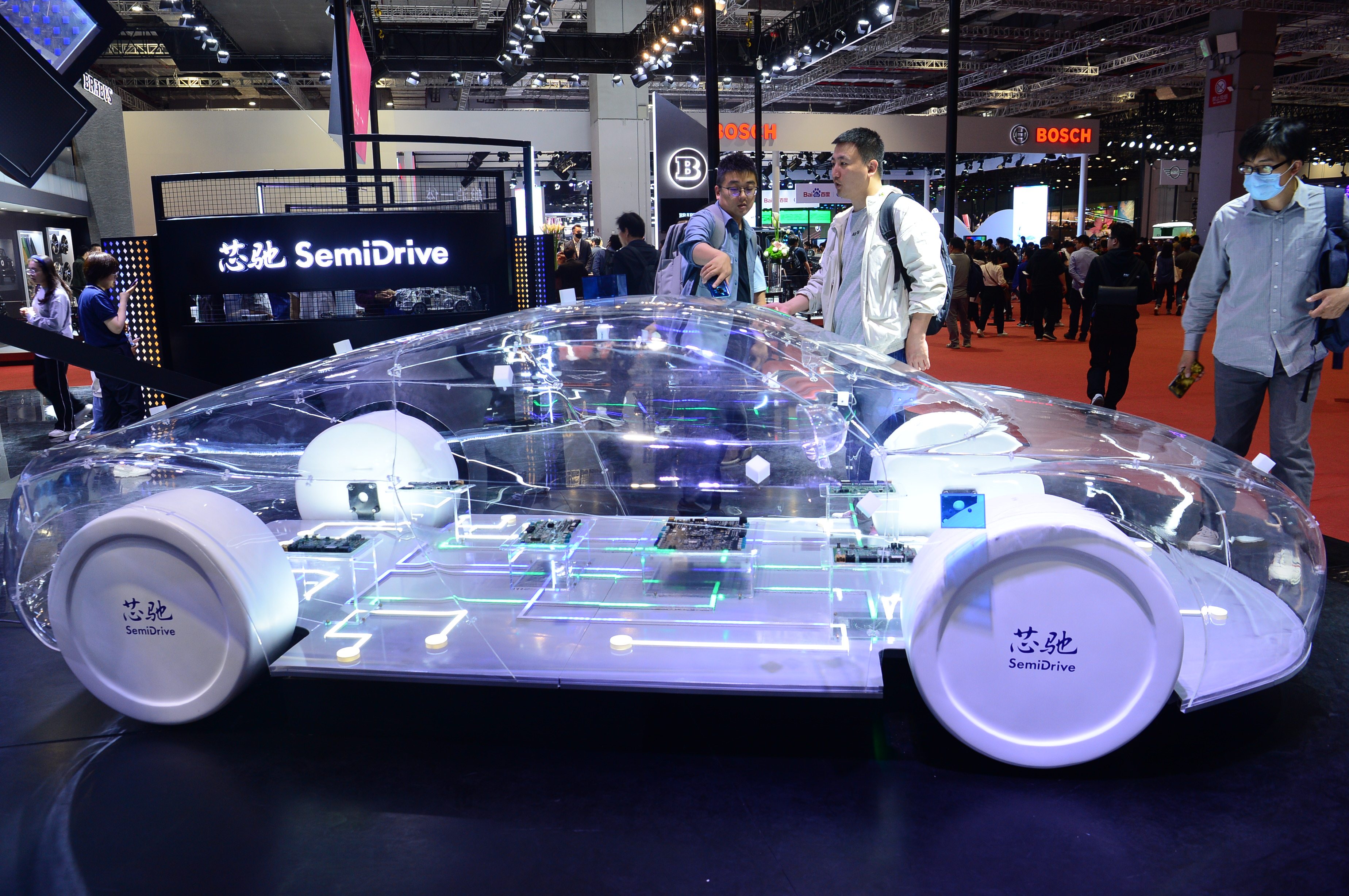 Visitors look at a display at the booth of SemiDrive Technology at the 2023 Shanghai Auto Show. Photo: Getty Images