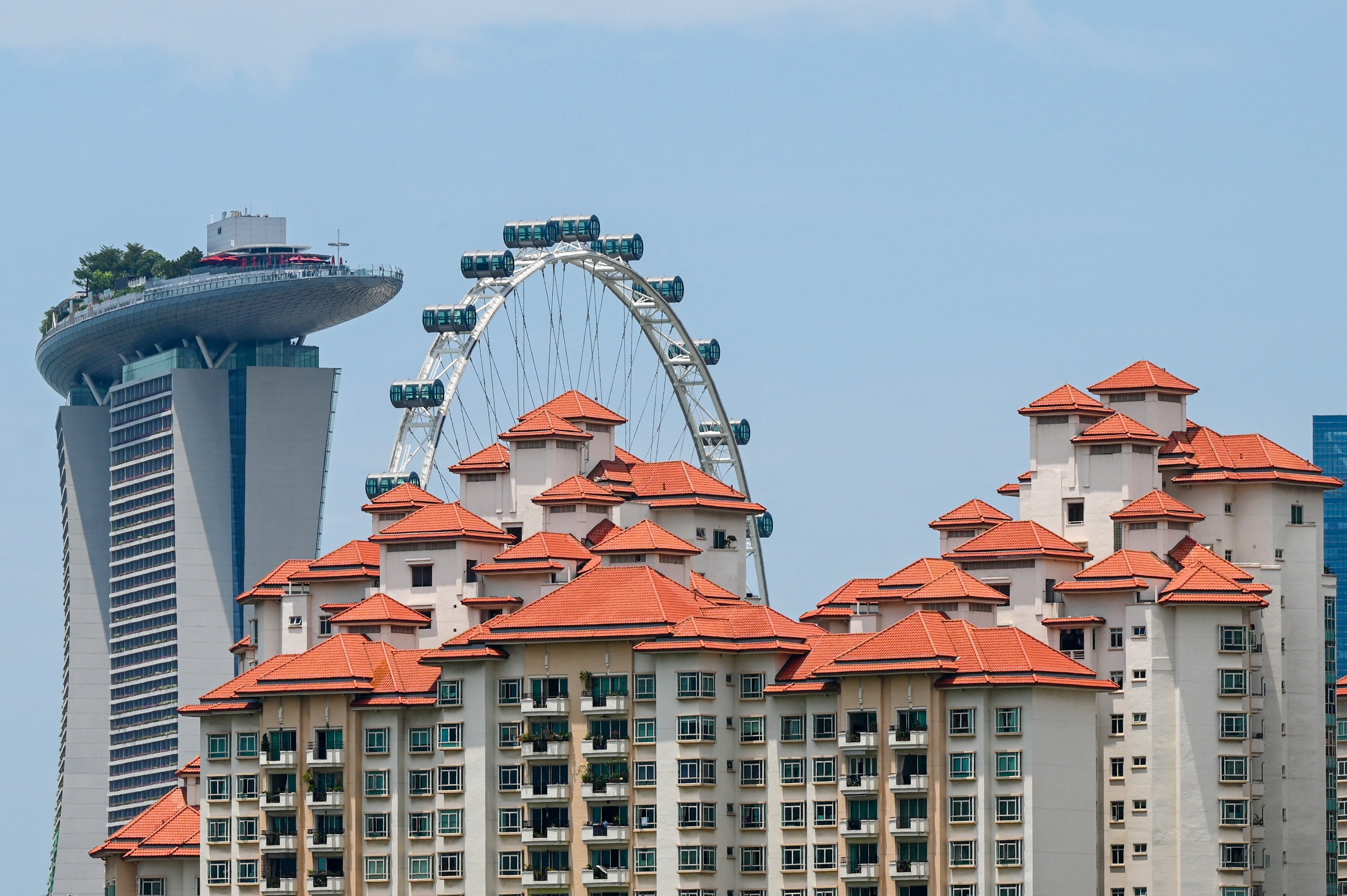 Private apartments are seen against the backdrop of the Marina Bay Sands hotel and the Singapore Flyer observatory wheel in Singapore. Photo: AFP