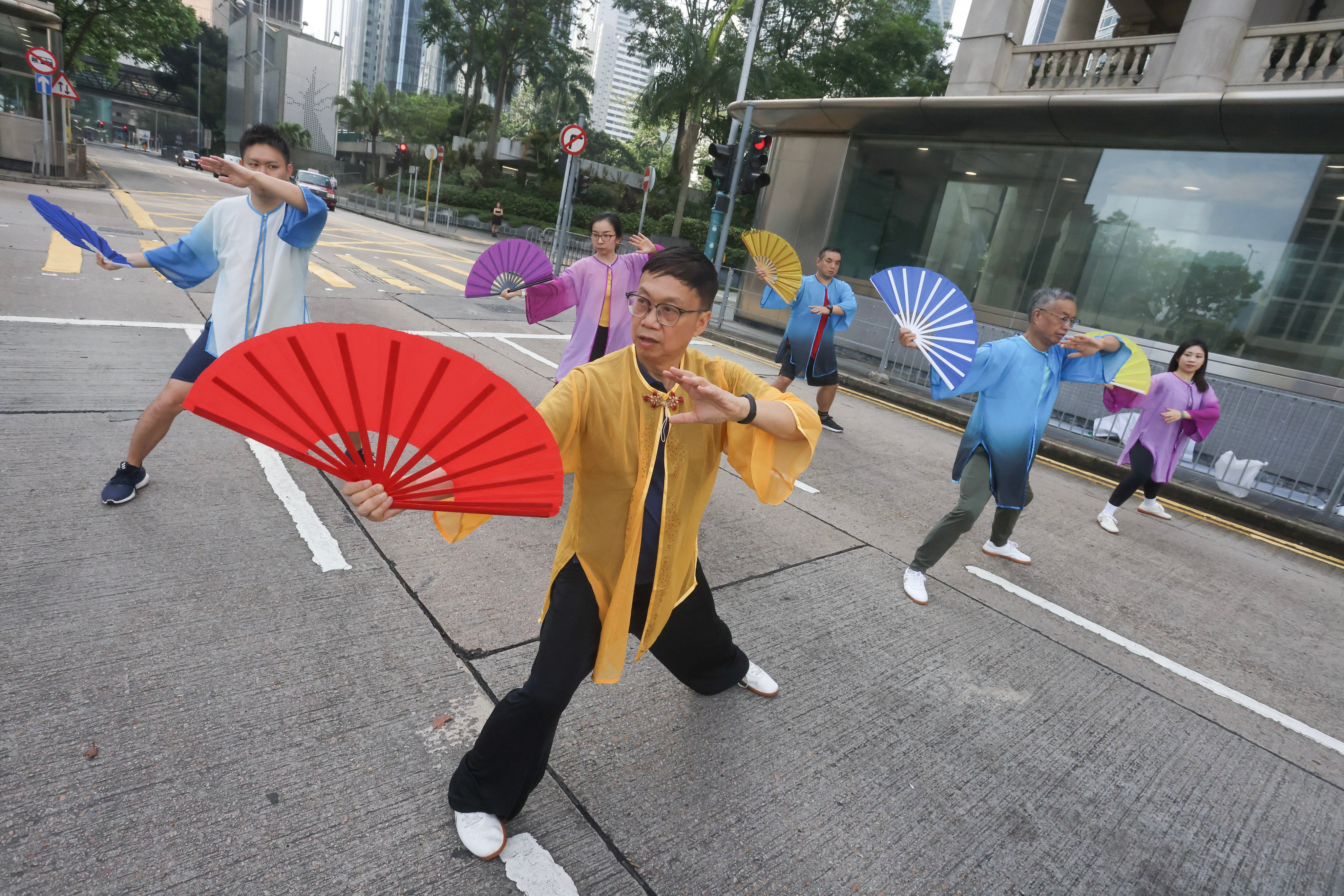 When Hongkonger Alfred Yu (centre) retired, he took up a number of activities, including teaching tai chi with fans. He says retirement allowed him to explore new possibilities, develop different skills and share them freely with others. Photo: Jonathan Wong