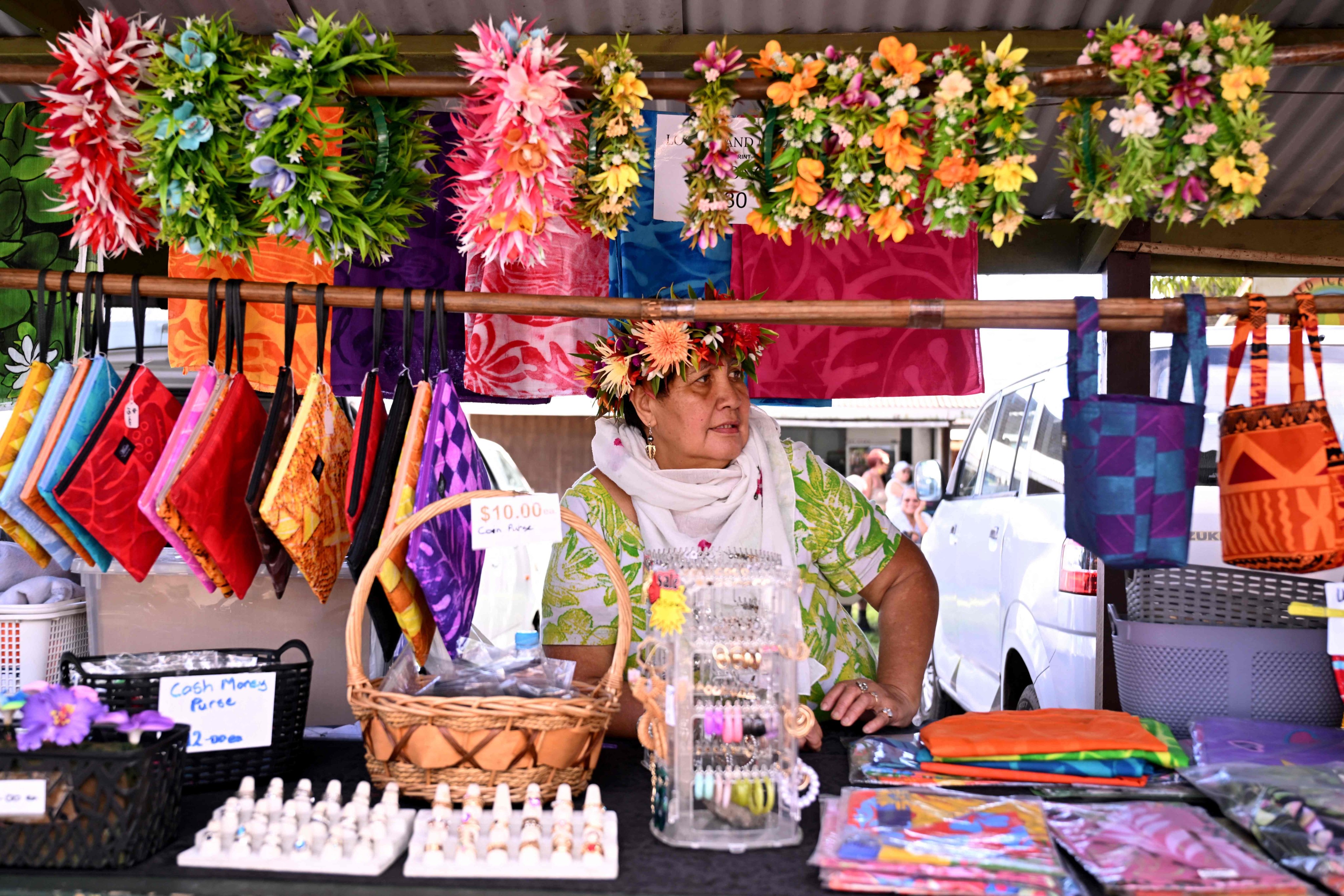 A stallholder displays her wares to tourists at a market on Rarotonga in the Pacific nation of the Cook Islands earlier this month. Photo: AFP