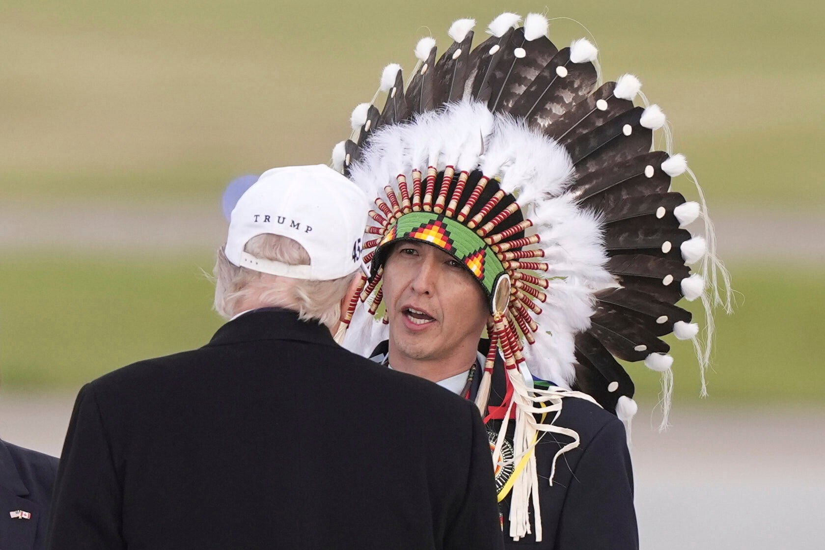 US President Donald Trump being greeted by Steven Crowchild in Calgary, Canada. Photo: AP