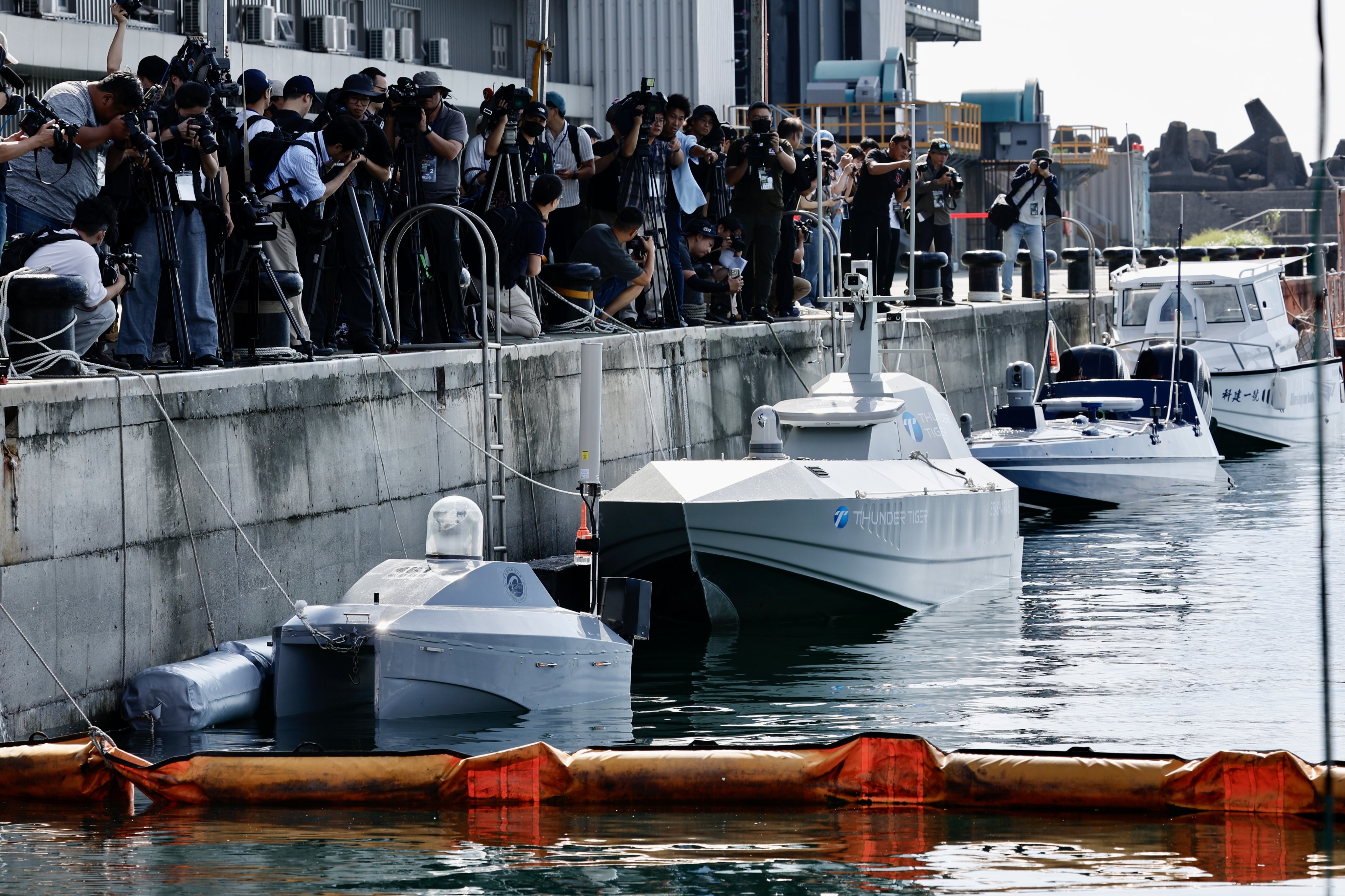 Journalists film the uncrewed surface vehicles ahead of demonstrations showcasing newly developed water surface drones, at Suao port in Yilan, Taiwan, on Tuesday. Photo: EPA-EFe