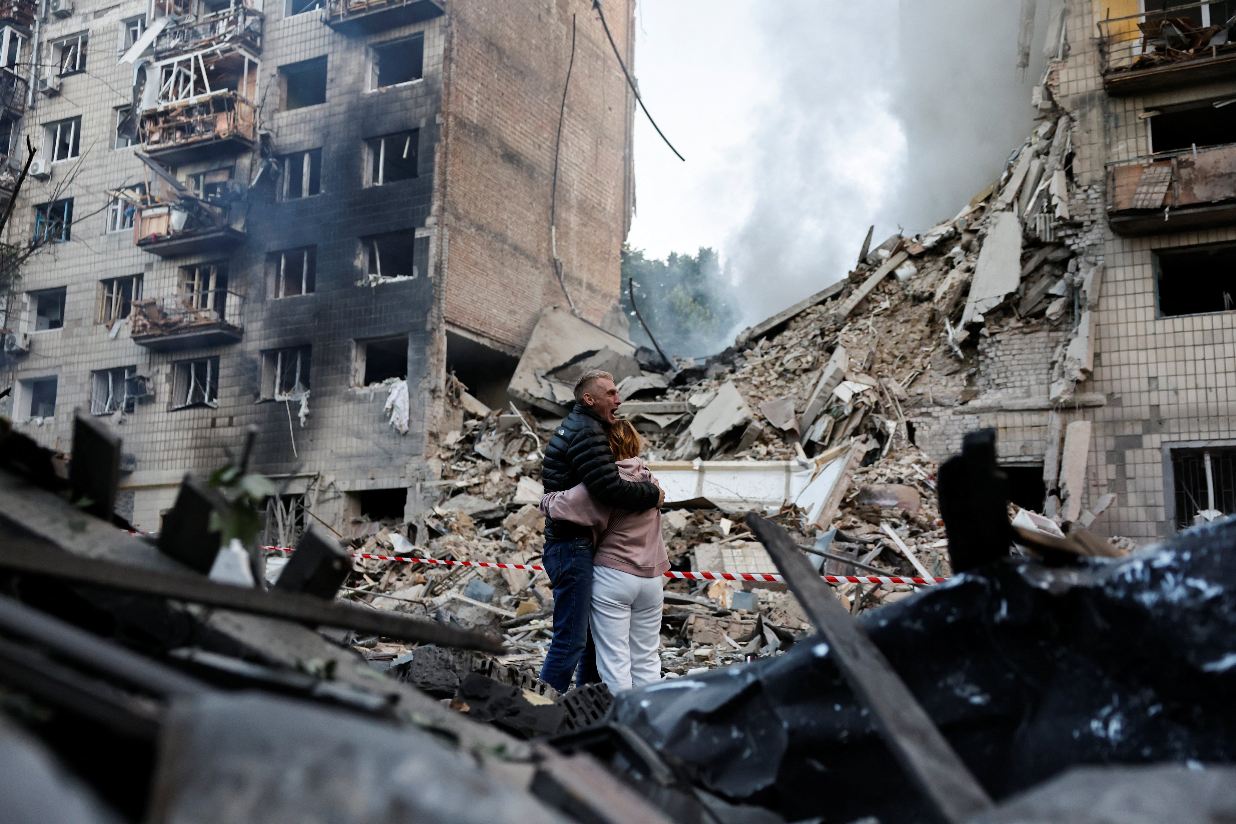 Residents in front of a Kyiv residential building damaged during a Russian strike. Photo: Reuters