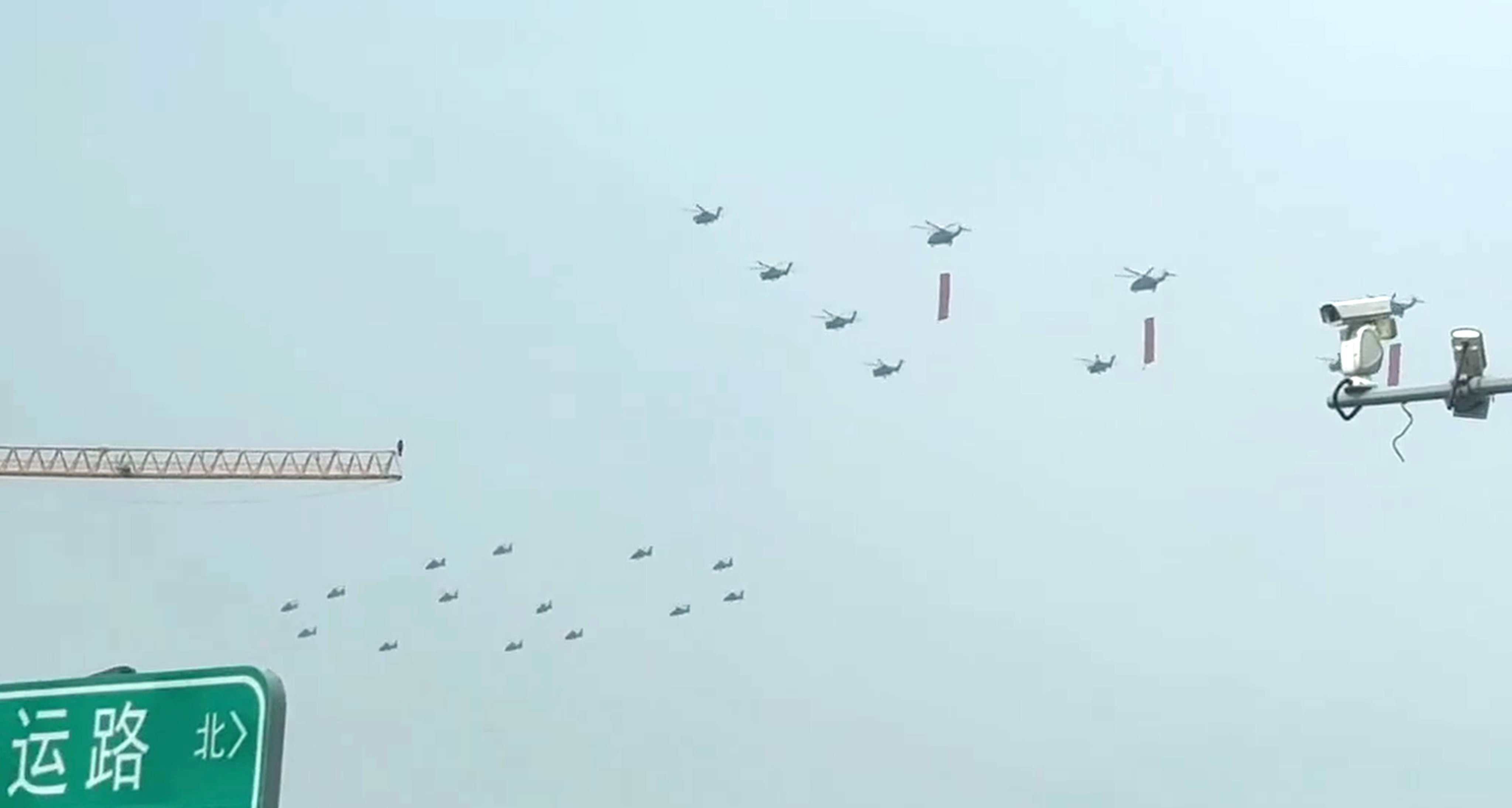 A clip posted to RedNote purportedly shows PLA helicopters flying in formation, some of them carrying red flags. Photo: Handout