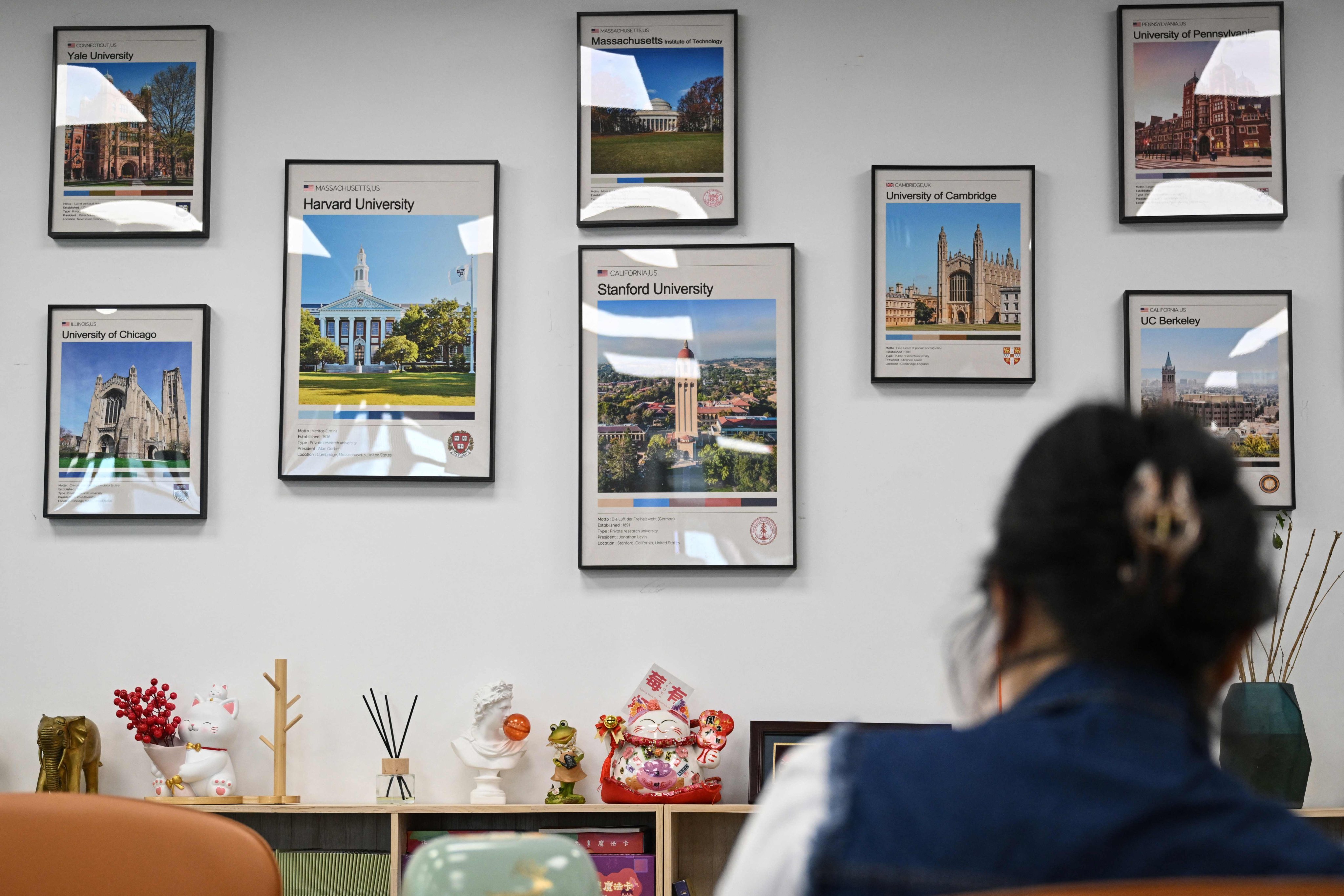 Posters of American and British universities, including Harvard University, are seen on the wall at an overseas education agency in Beijing on May 29. Photo: AFP