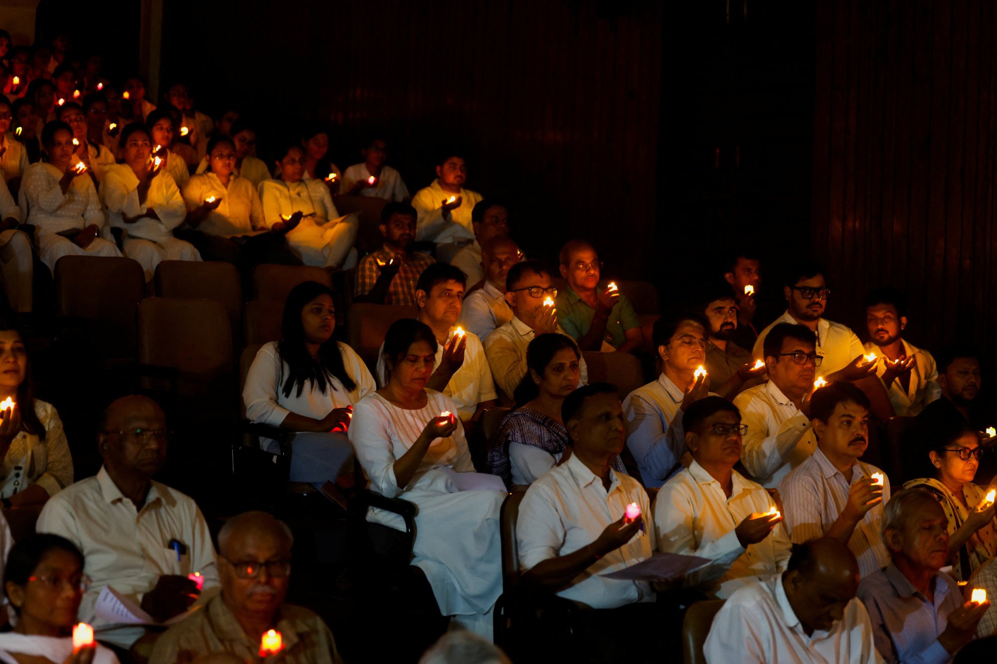 People hold candles as they take part in a special prayer ceremony on Tuesday for the victims of Air India flight 171. Photo: Reuters People hold candles as they take part in a special prayer ceremony on Tuesday for the victims of Air India flight 171. Photo: Reuters