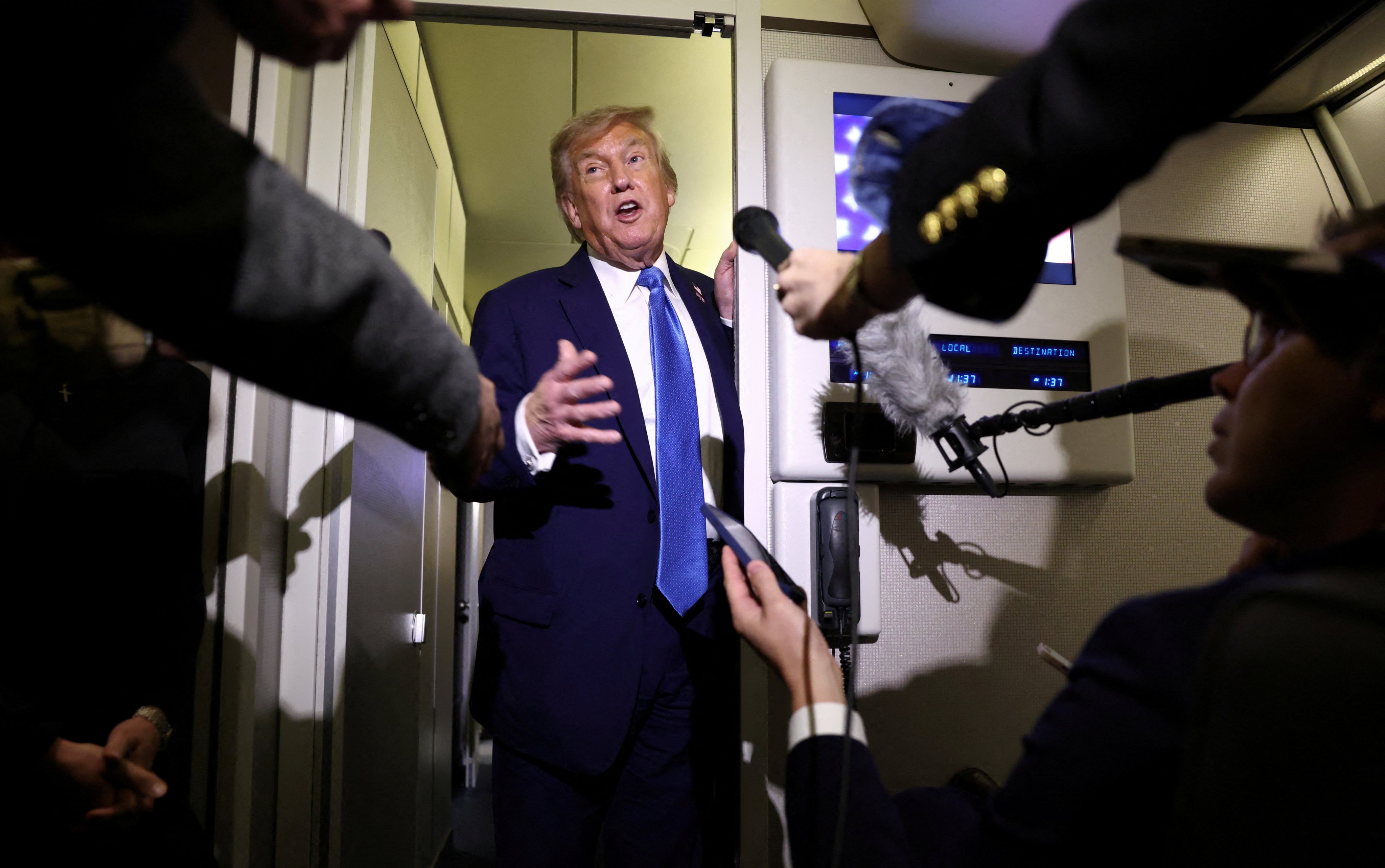 US President Donald Trump speaks to reporters aboard Air Force One after departing early from the the G7 summit in Canada to return to Washington. Photo: Reuters