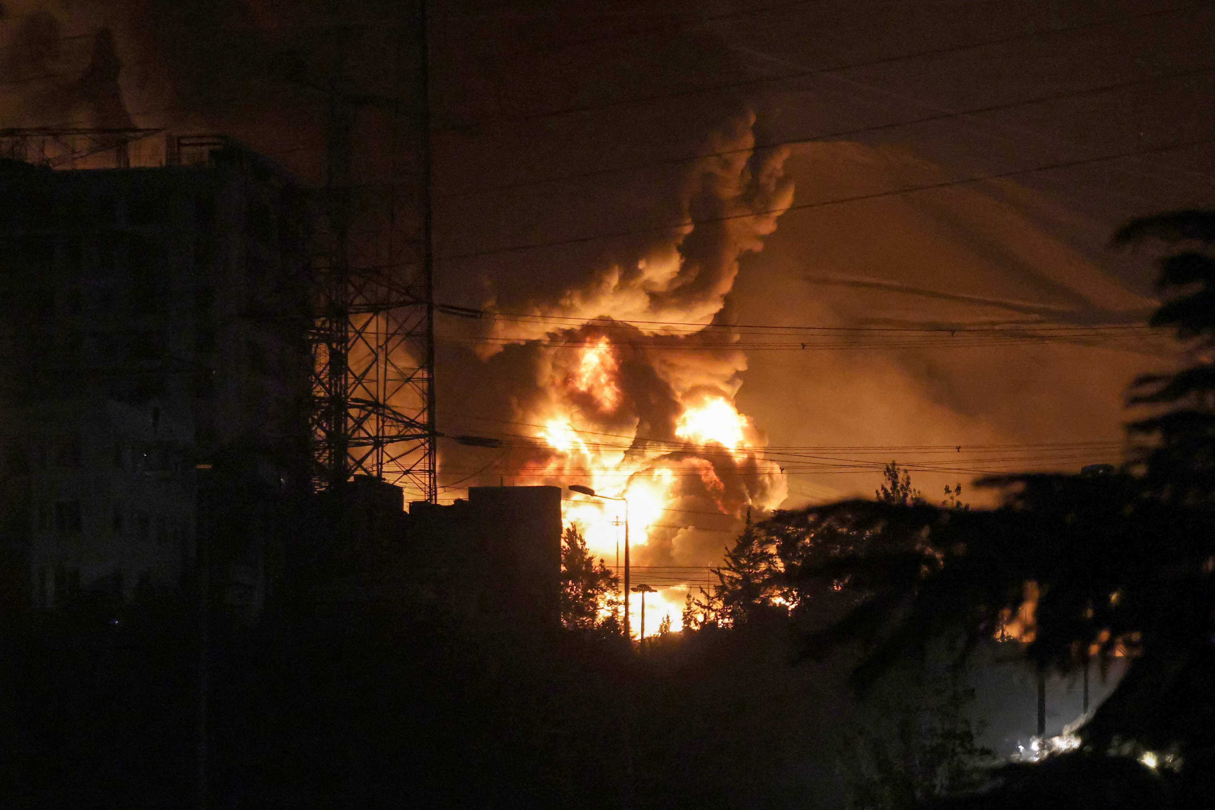 A fire blazes at an oil depot northwest of Iran’s capital Tehran on Sunday following an Israeli strike. Photo: AFP