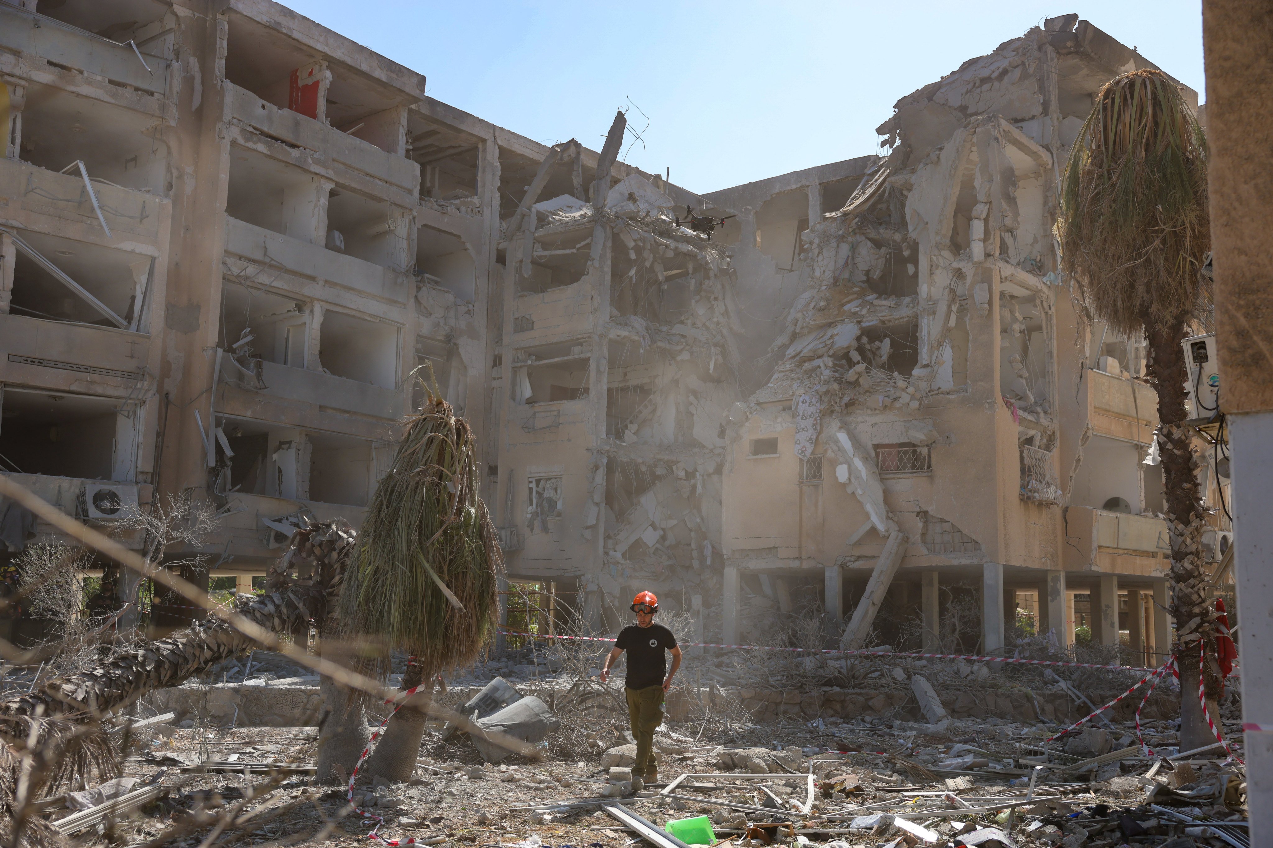 Israeli emergency teams work at the site of an Iranian missile strike in a residential area in Holon, central Israel, on Thursday. China’s embassy said evacuations of Chinese to Egypt will start on Friday. Photo: EPA-EFE