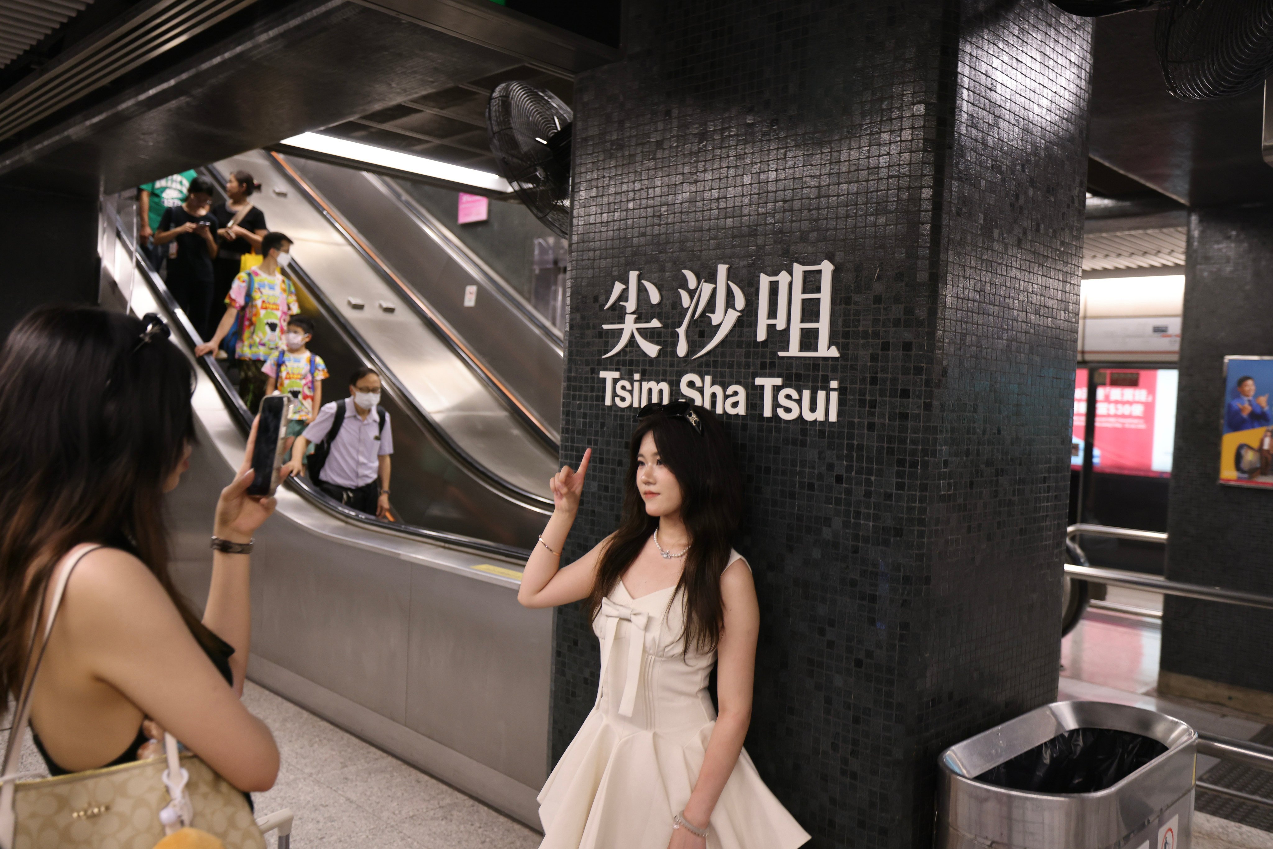 Tourists take photos on the platform of Tsim Sha Tsui MTR station on June 14. Photo: Nora Tam