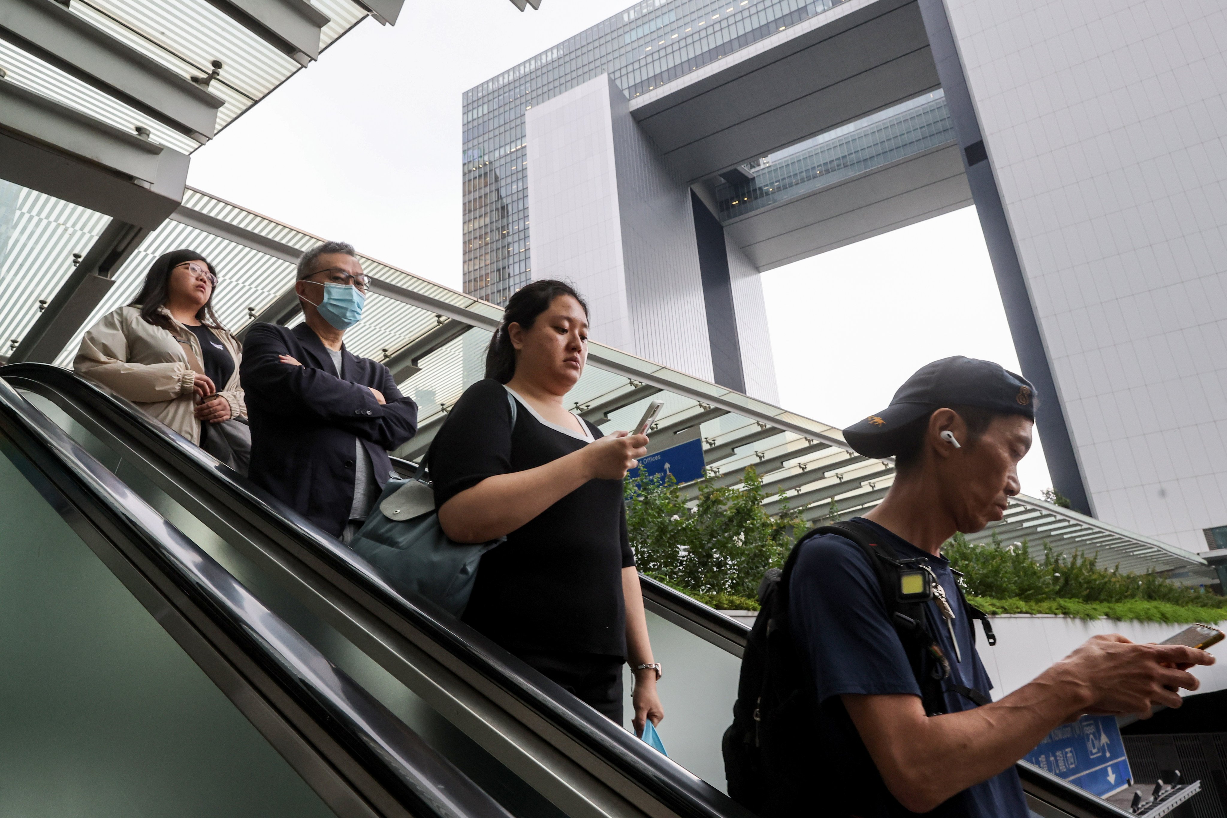 Civil servants leave work in Admiralty. Under the proposal, senior civil servants would undergo appraisals annually, with those underperforming facing consequences such as pay freezes. Photo: Edmond So