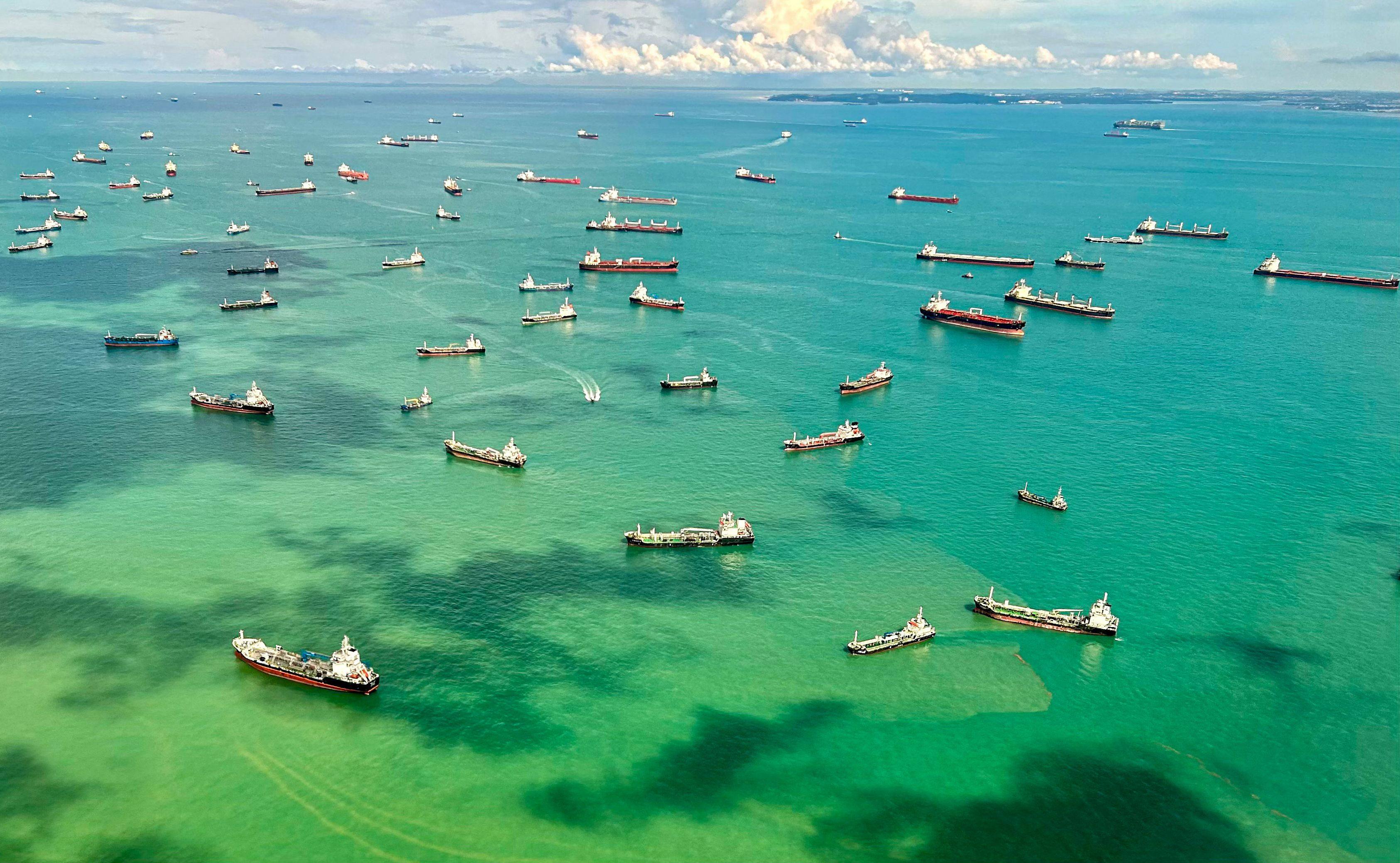 An aerial view taken from a commercial flight shows cargo ships docked along the strait in Singapore on April 7. Photo: AFP