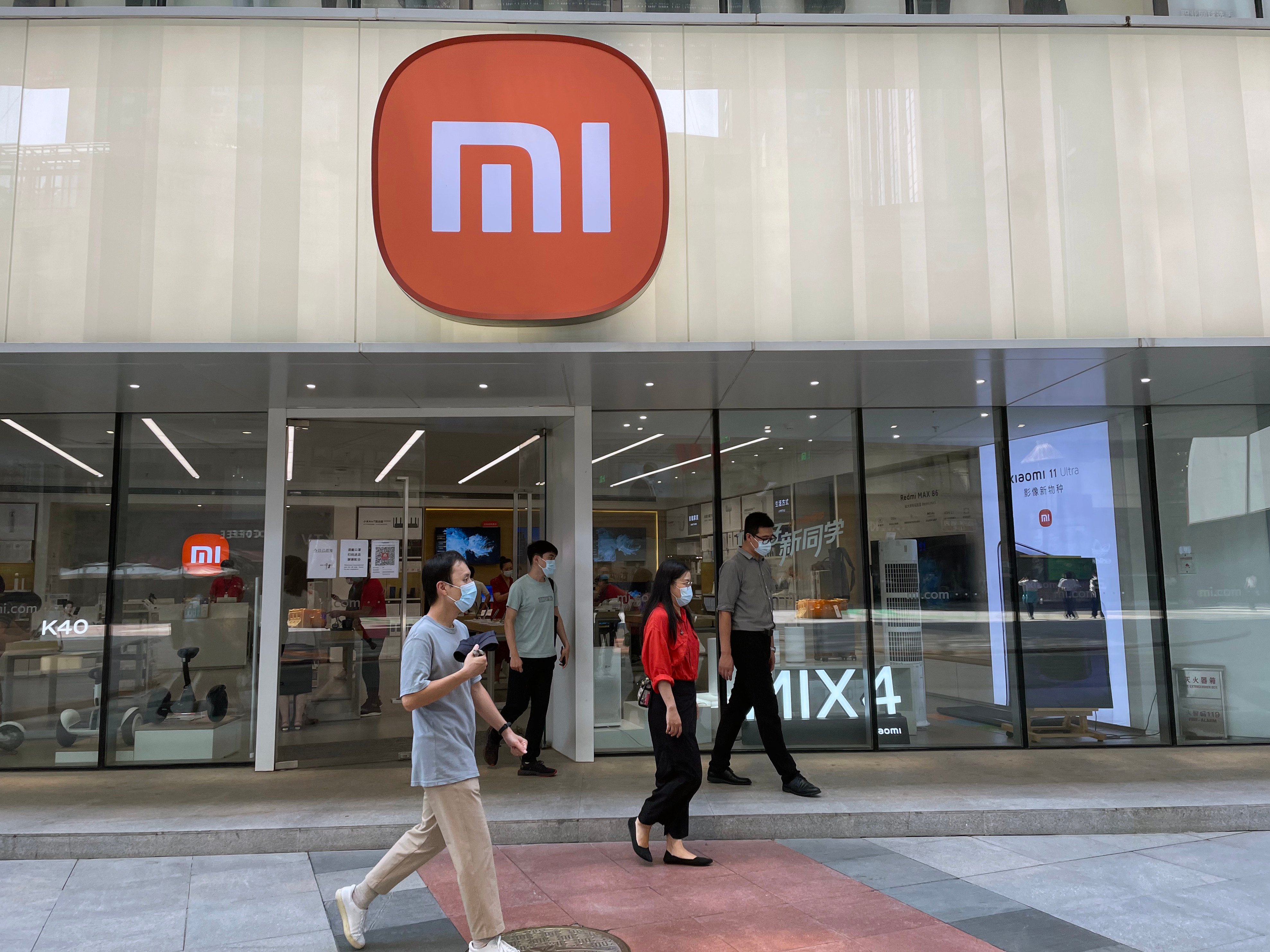 People walk past a Xiaomi store in Beijing in September 2021. Photo: Simon Song