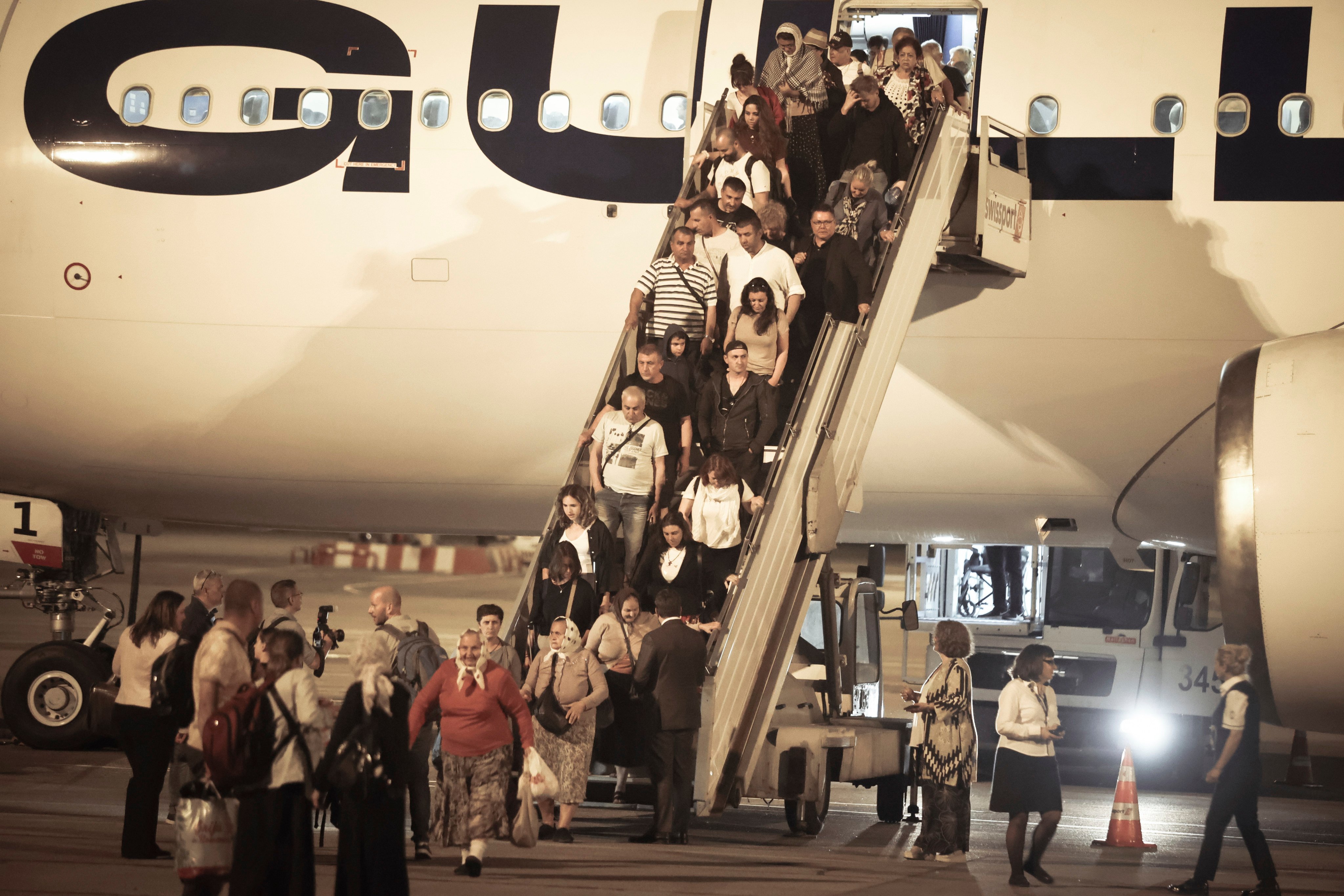 Bulgarian citizens evacuated from Israel, along with dozens of foreign nationals from Slovenia, the US, Belgium, Albania, Kosovo and Romania, arrive in Sofia. Photo: AP