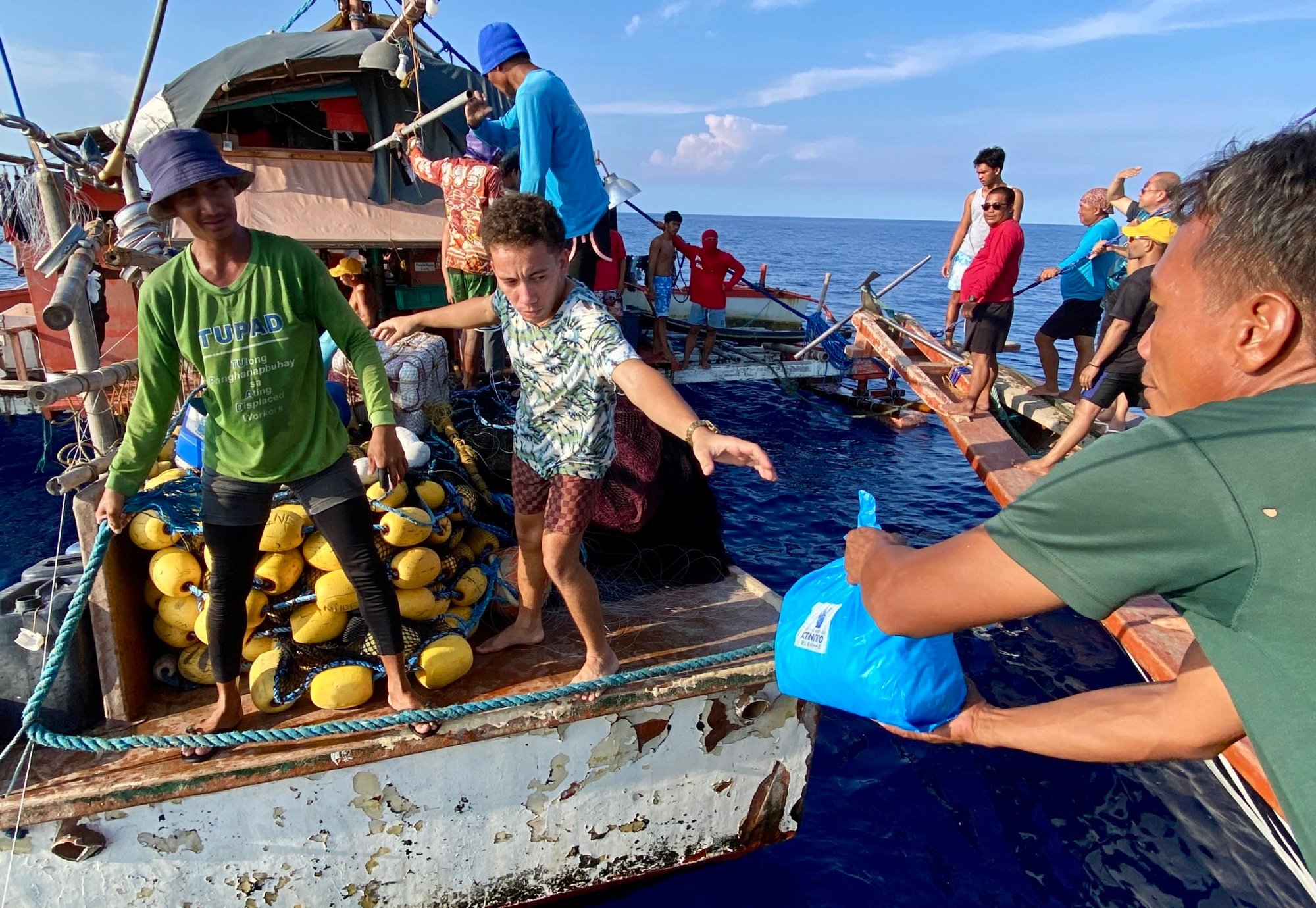 Filipino fishers receive relief goods near Scarborough Shoal in May last year. Photo: EPA-EFE Filipino fishers receive relief goods near Scarborough Shoal in May last year. Photo: EPA-EFE