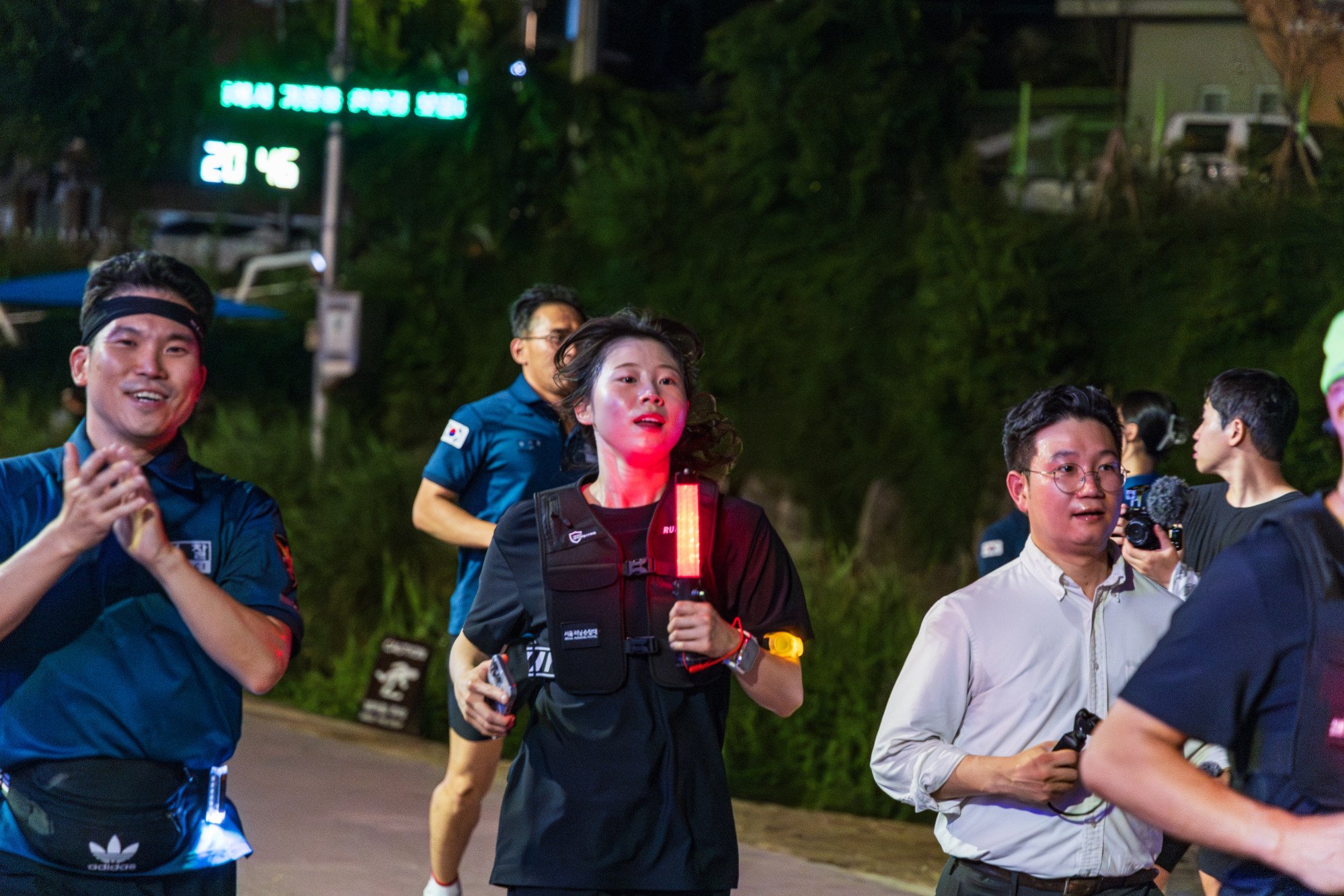 Members of the Be Ready Running Club jog along a stream in northwestern Seoul with police officers as part of the city’s Running Patrol programme. Photo: Kim Jung-yeop