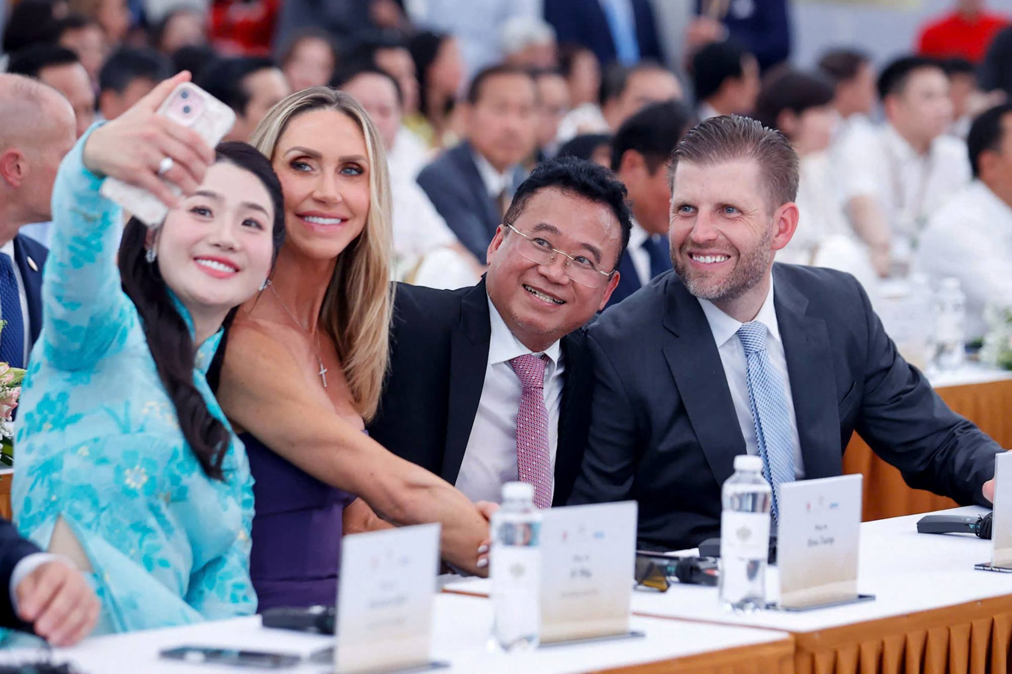 Eric Trump and his wife Lara Trump (second from left) take a selfie with Dang Thanh Tam (second from right) as they attend the groundbreaking ceremony for the Hung Yen golf course project. Photo: AFP