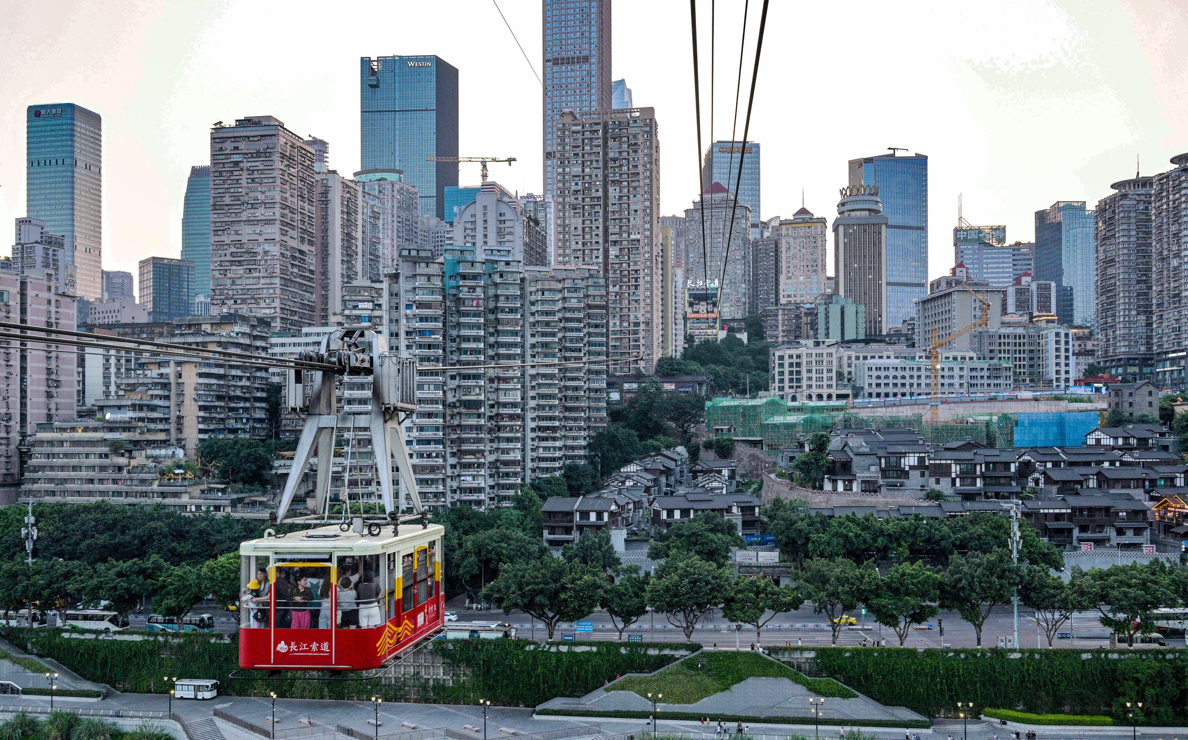 People ride a cable car in Chongqing. Photo: AFP