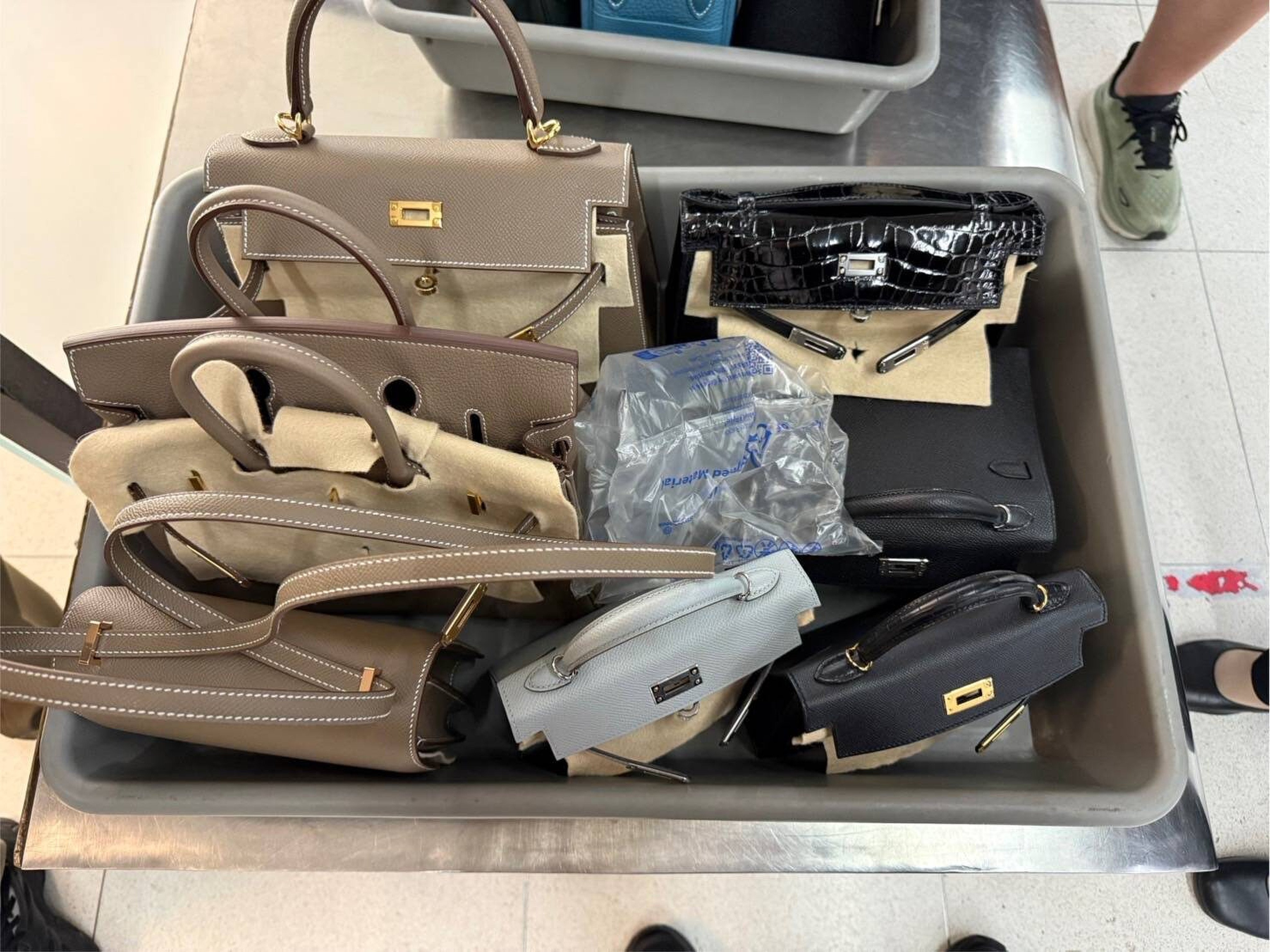 The suspect is alleged to have stolen 14 pre-owned Hermes bags and other items. Photo: Suvarnabhumi Immigration