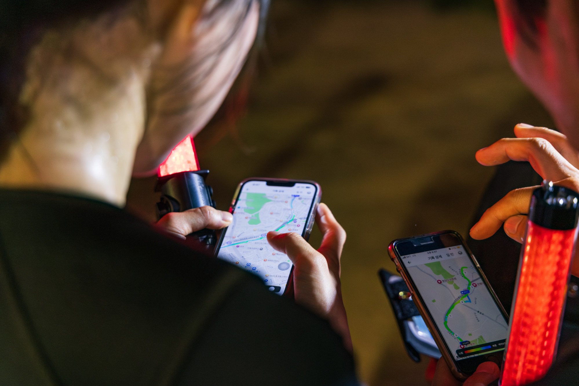 Two members of the Be Ready Running Club look at a map that logs the route they have run under Seoul’s Running Patrol programme. Photo: Kim Jung-yeop