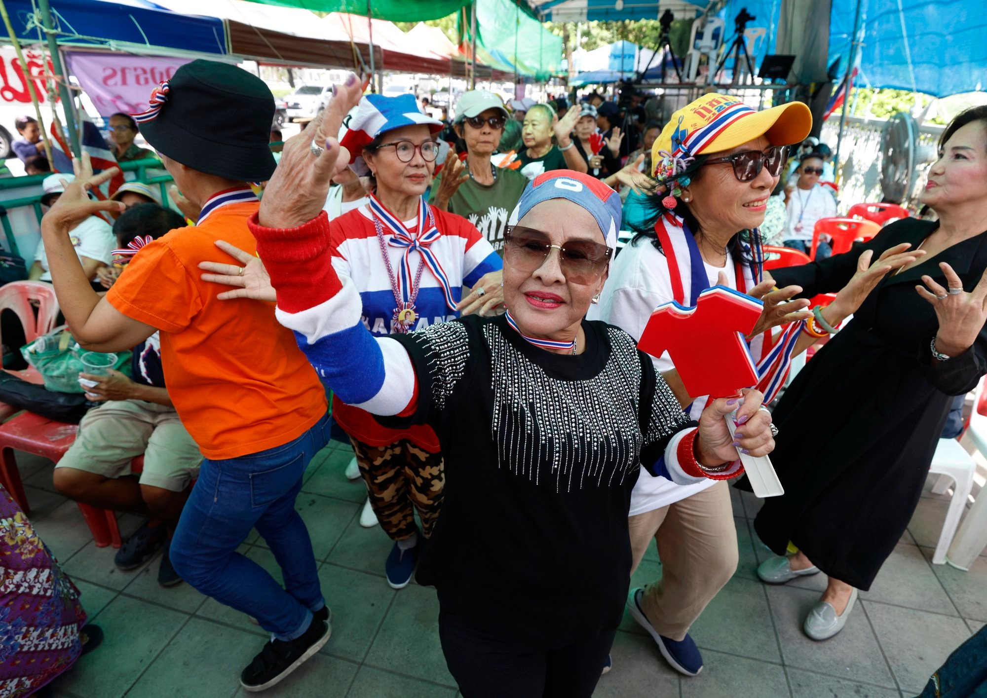 Protesters dance during a rally calling for the resignation of the Thai prime minister near the Government House in Bangkok on Friday. Photo: EPA-EFE Protesters dance during a rally calling for the resignation of the Thai prime minister near the Government House in Bangkok on Friday. Photo: EPA-EFE