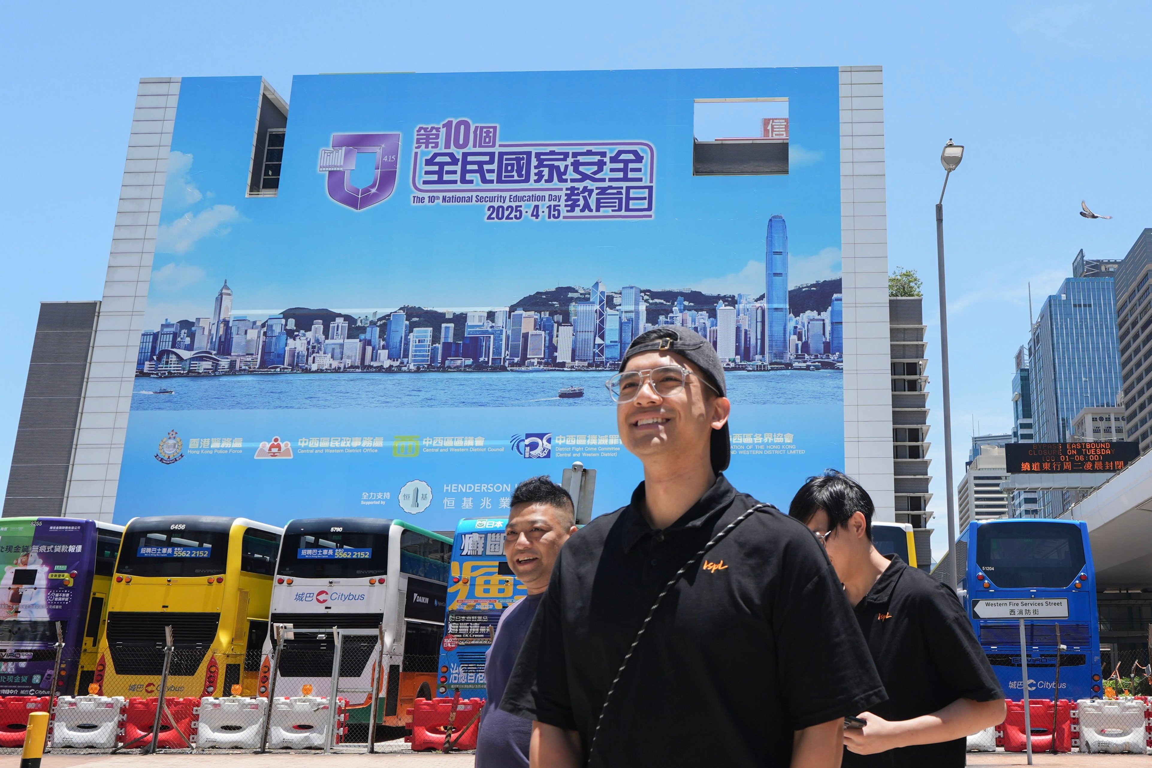 People walk past a billboard for National Security Education Day in Sheung Wan, Hong Kong, on May 12. Photo: Eugene Lee