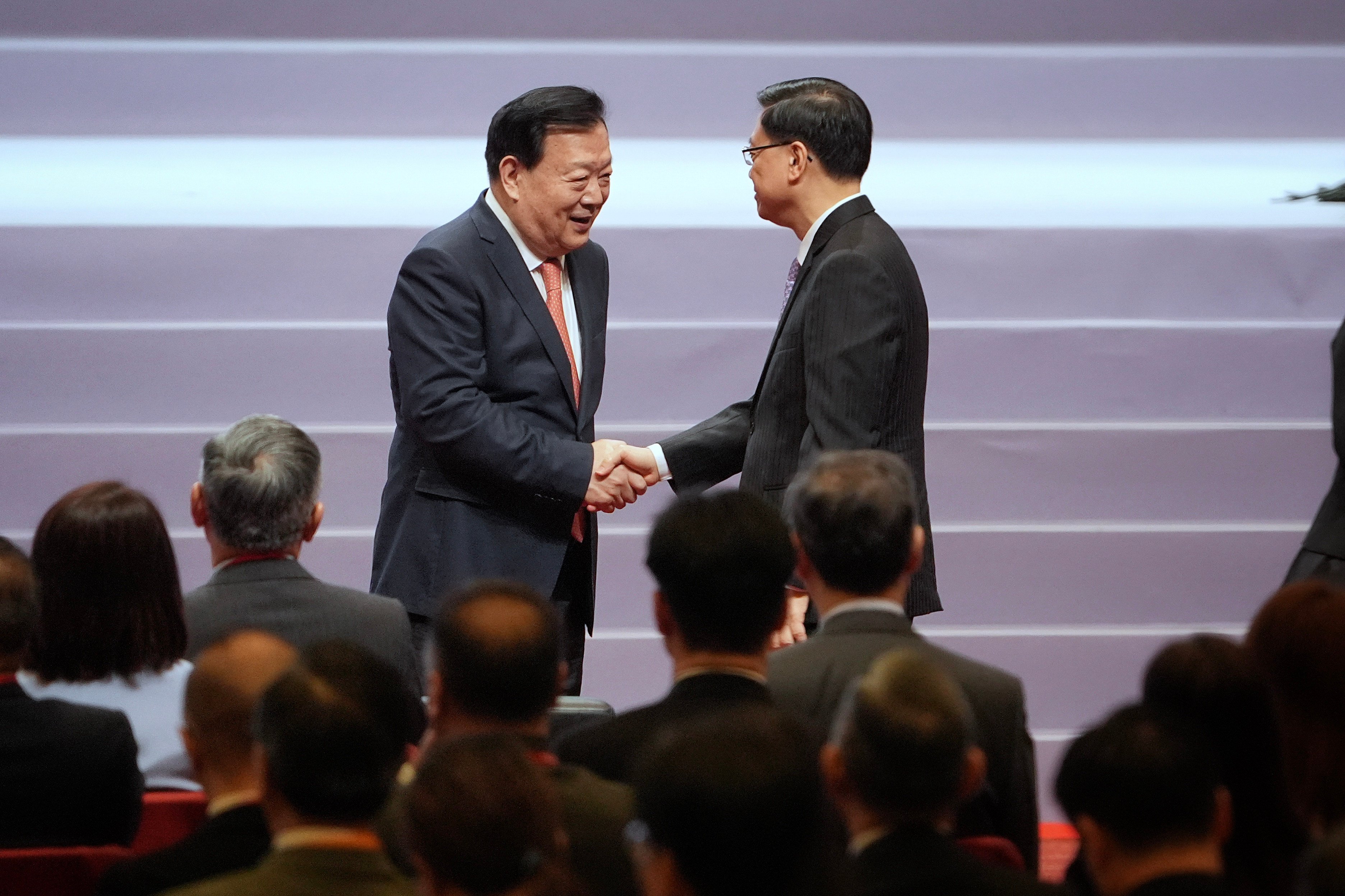 Mr Xia Baolong shakes hand with John Lee Ka-chiu in the opening ceremony of the National Security Law forum on Saturday. Photo: Elson Li