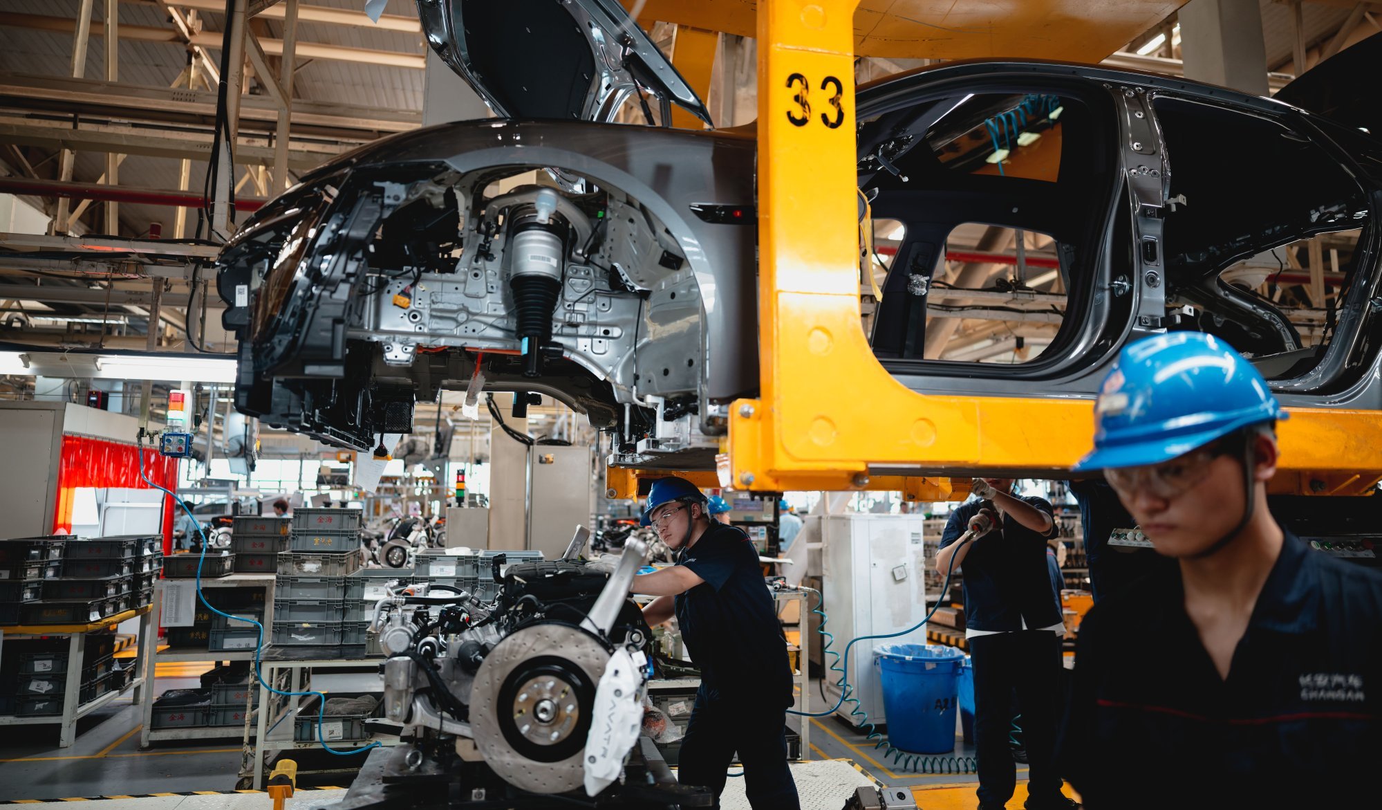 Laborers work on an assembly line during the organized press tour in the AVATR EV factory, in Chongqing, China, May 20 2025. Photo: EPA-EFE/ALEX PLAVEVSKI Laborers work on an assembly line during the organized press tour in the AVATR EV factory, in Chongqing, China, May 20 2025. Photo: EPA-EFE/ALEX PLAVEVSKI