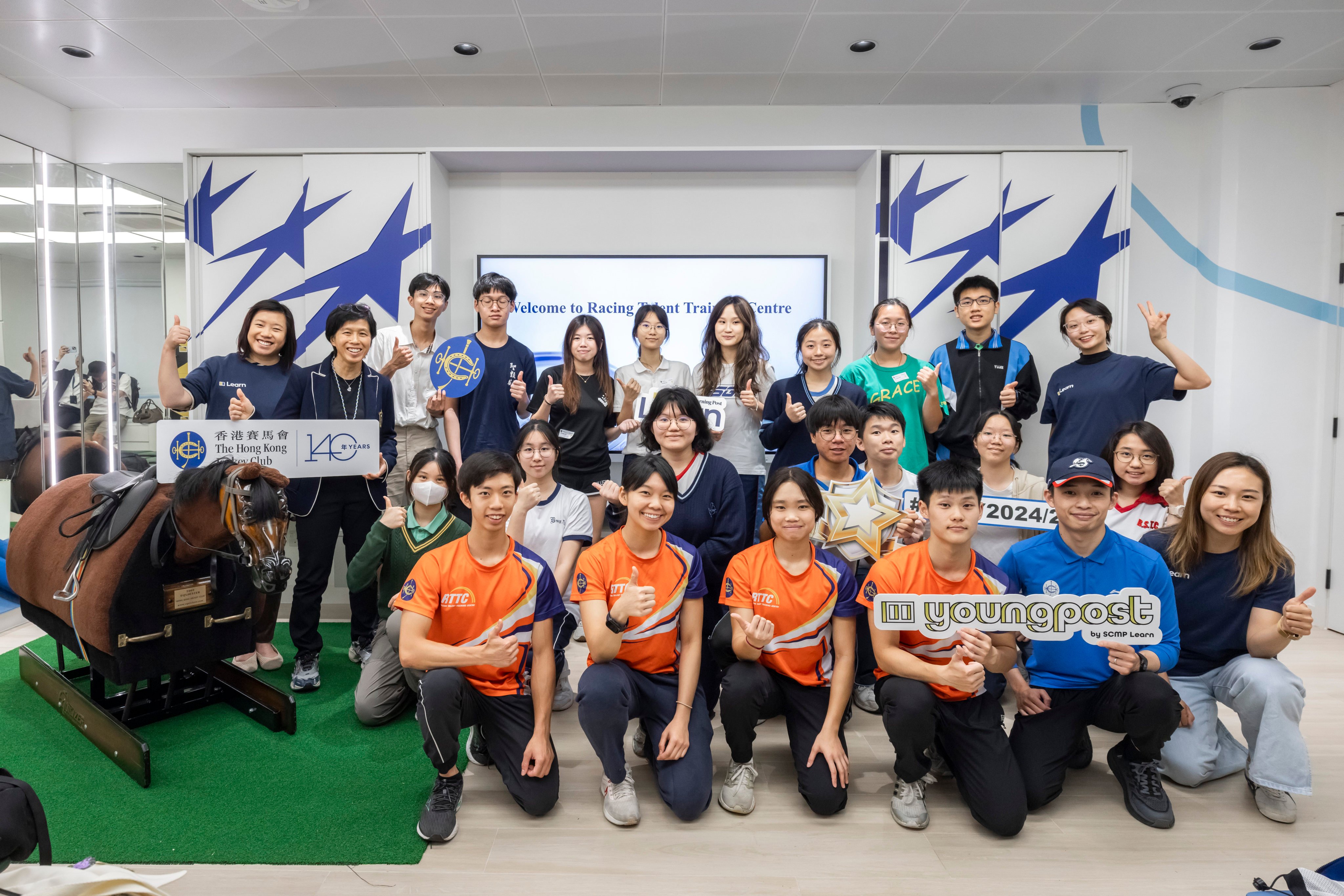 Nominees for the Student of the Year Awards 2024/25 enjoyed an exclusive and inspiring visit to The Hong Kong Jockey Club Racing Talent Training Centre. Accompanying them were Krizia Li, Head of SCMP Learn (back row, first from left) and Amy Chan, HKJC Head of Racing Talent Training and Headmistress of the Apprentice Jockeys’ School (back row, second from left). Photo: Handout
