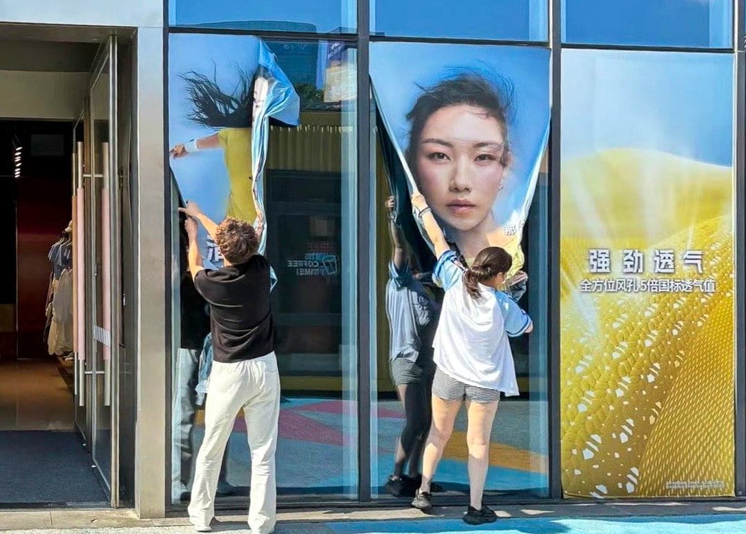 Posters of Chinese actress Nashi are ripped from a mainland store’s window amid the controversy over the fraud she committed to get ahead in her studies. Photo: SCMP
