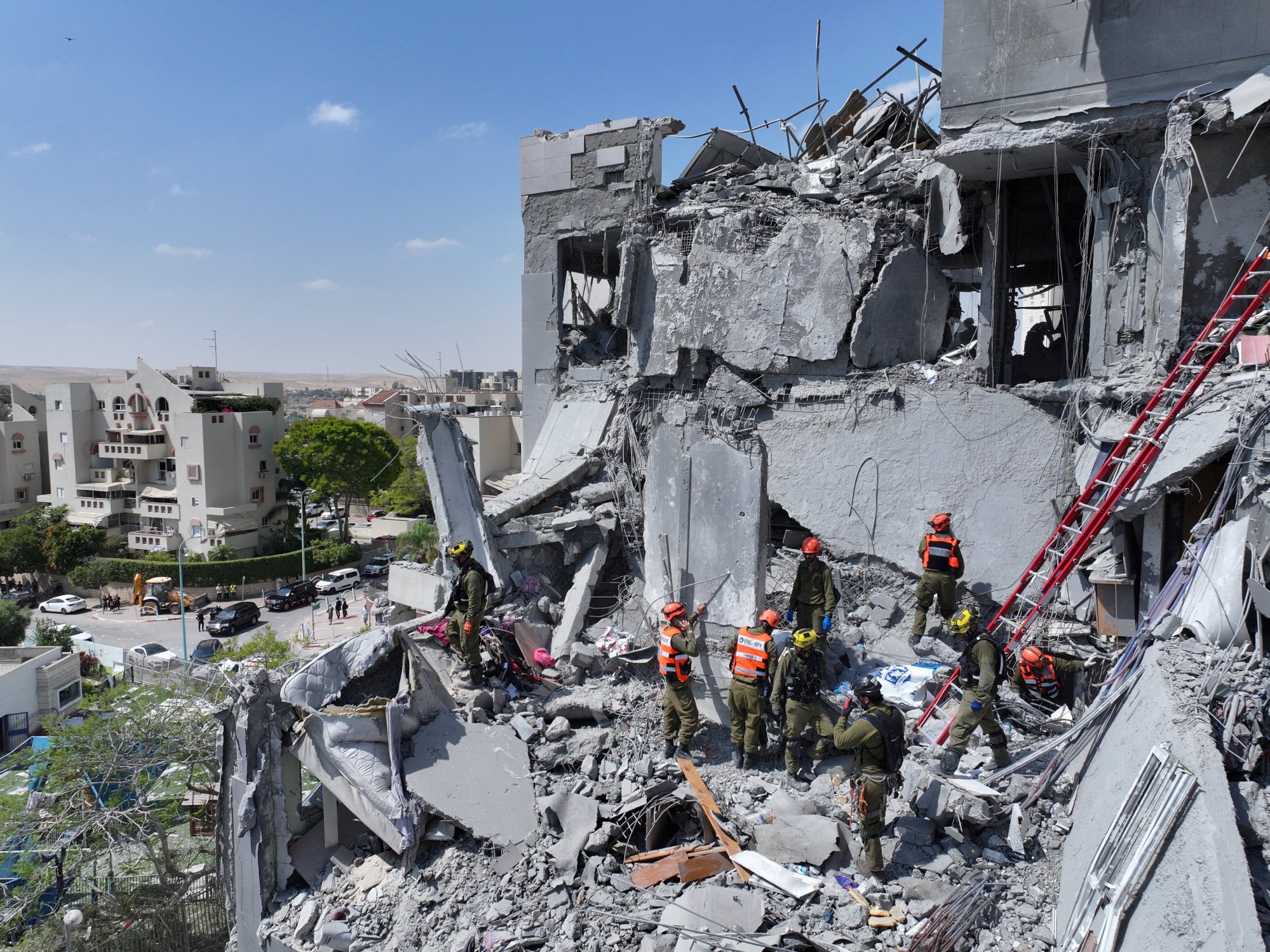 Emergency personnel working at an affected residential site, following an early morning missile attack from Iran on Israel, in Be’er Sheva, Israel, on Tuesday. Photo: Reuters Emergency personnel working at an affected residential site, following an early morning missile attack from Iran on Israel, in Be’er Sheva, Israel, on Tuesday. Photo: Reuters