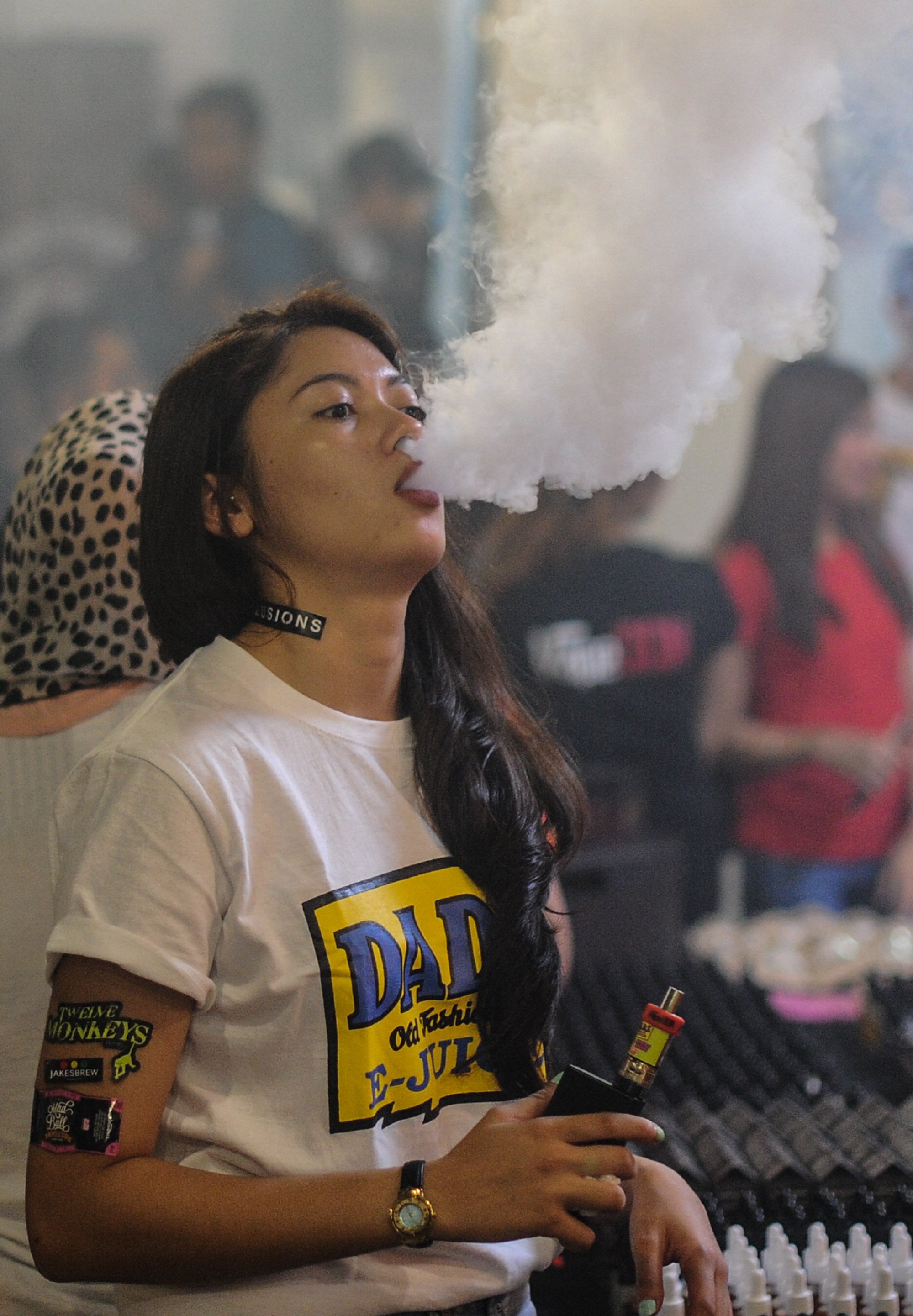 A promoter smokes an e-cigarette at a vape expo in Kuala Lumpur in 2015. Photo: AFP A promoter smokes an e-cigarette at a vape expo in Kuala Lumpur in 2015. Photo: AFP