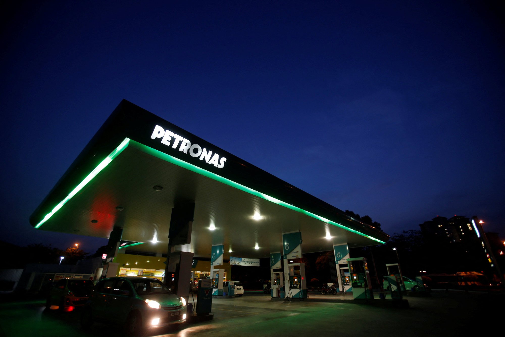 A motorist pumps petrol at a Petronas gas station in Putrajaya. Malaysia is planning to go ahead with petrol subsidy cuts as early as July. Photo: Reuters A motorist pumps petrol at a Petronas gas station in Putrajaya. Malaysia is planning to go ahead with petrol subsidy cuts as early as July. Photo: Reuters