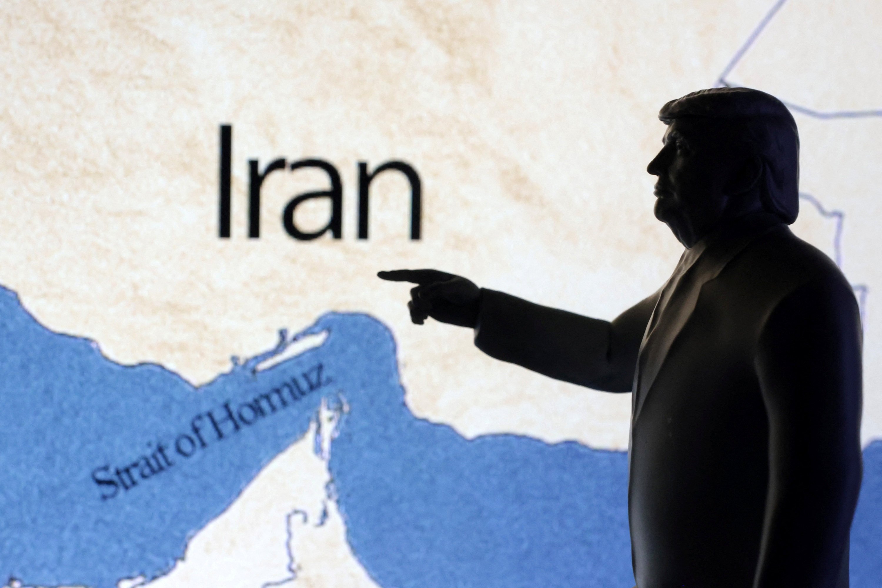 Illustration depicts a map showing the Strait of Hormuz and Iran is seen behind a 3D printed miniature of US President Donald Trump. Photo: Reuters / Dado Ruvic / Illustration